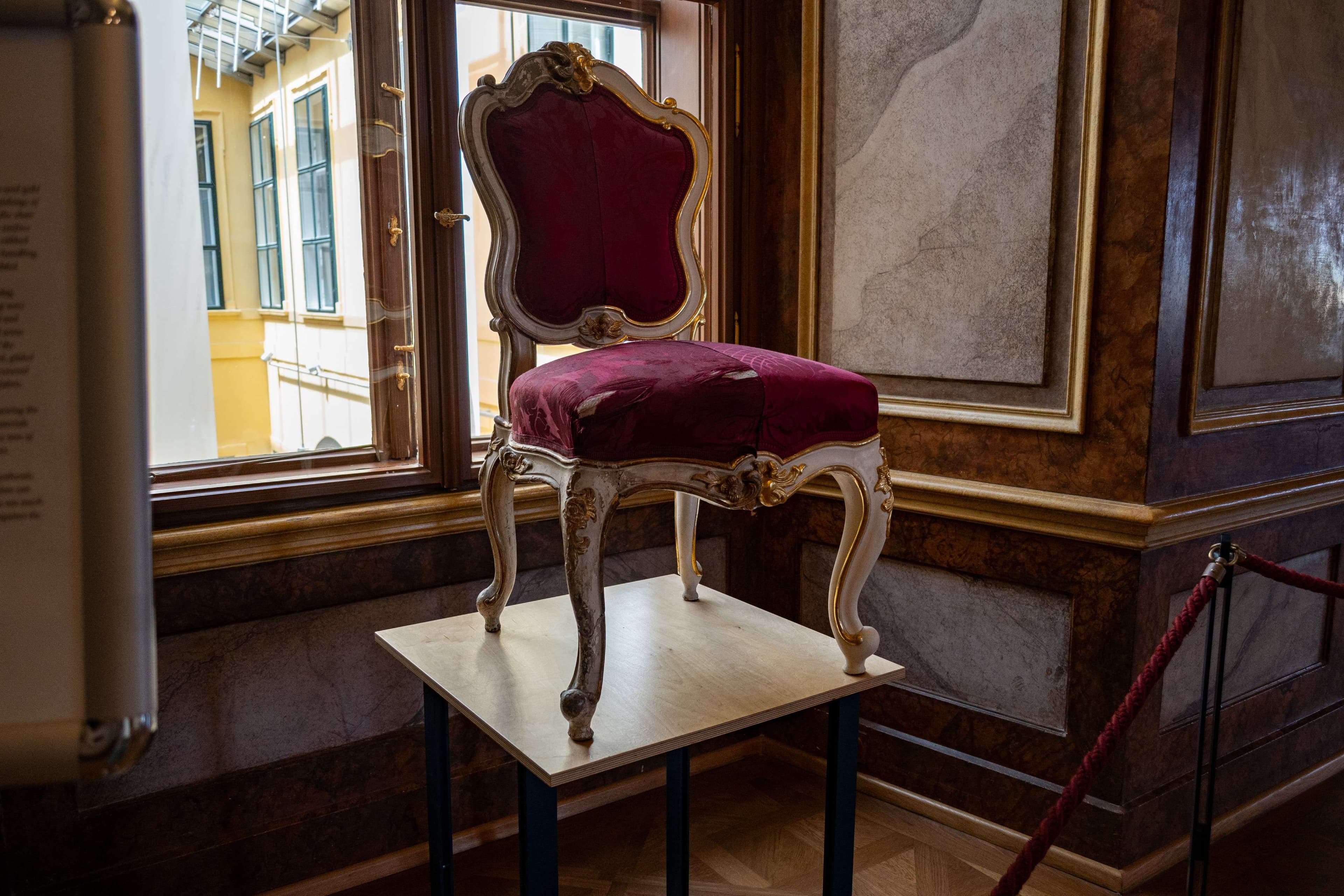 There is a chair that is sitting on a table in front of a window.