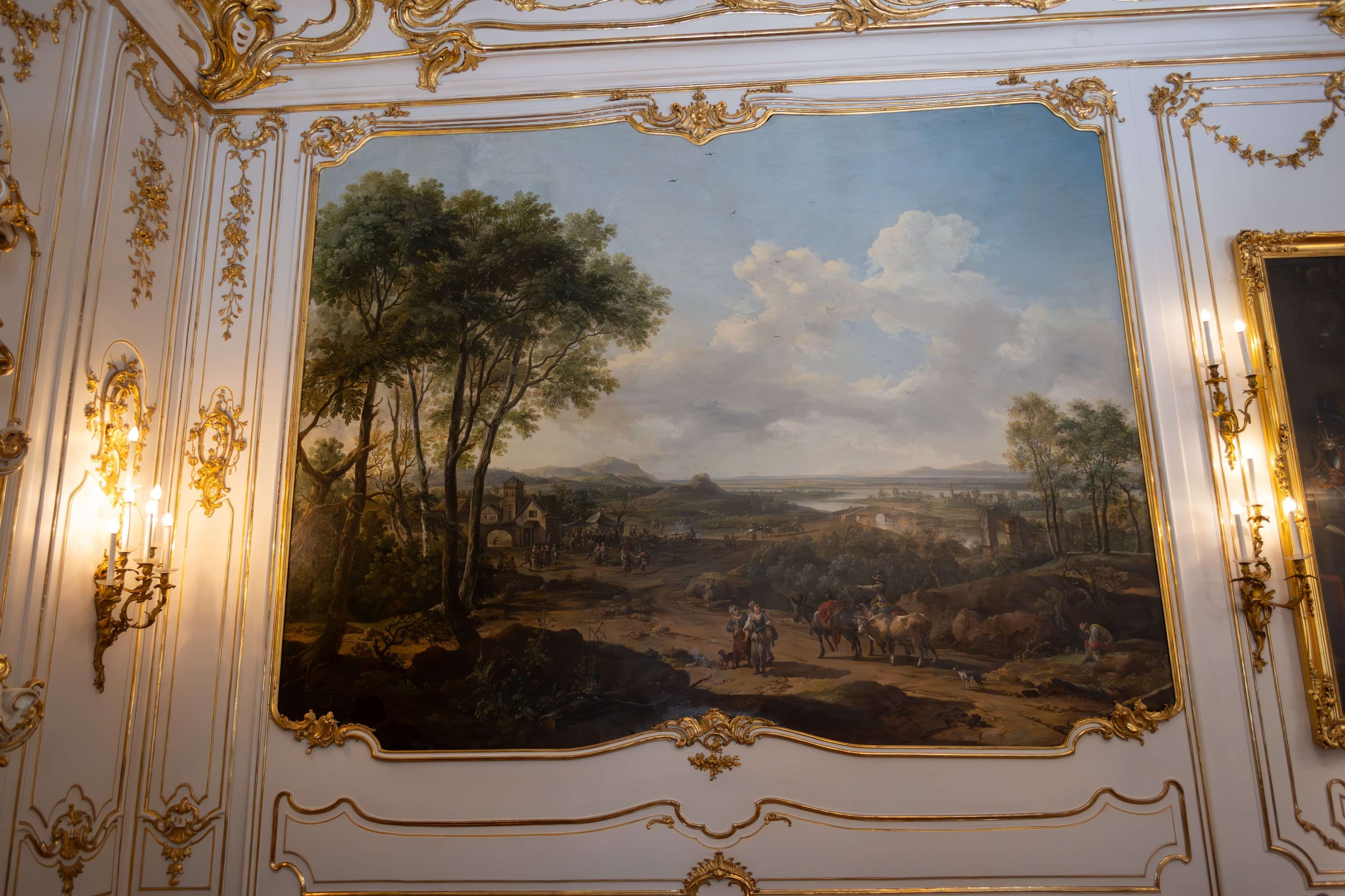 Painting of a painting of a landscape on a wall in a room.