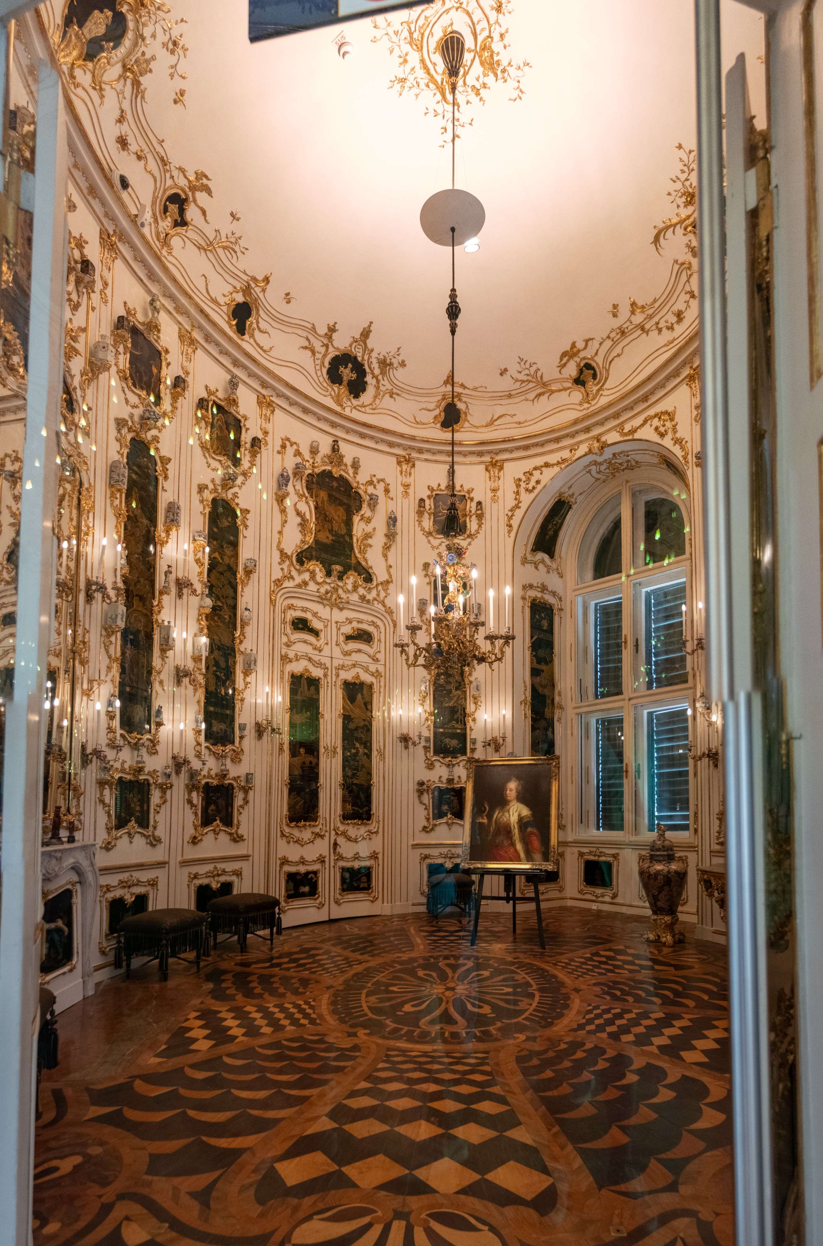 There is a room with a chandelier and a table in it.