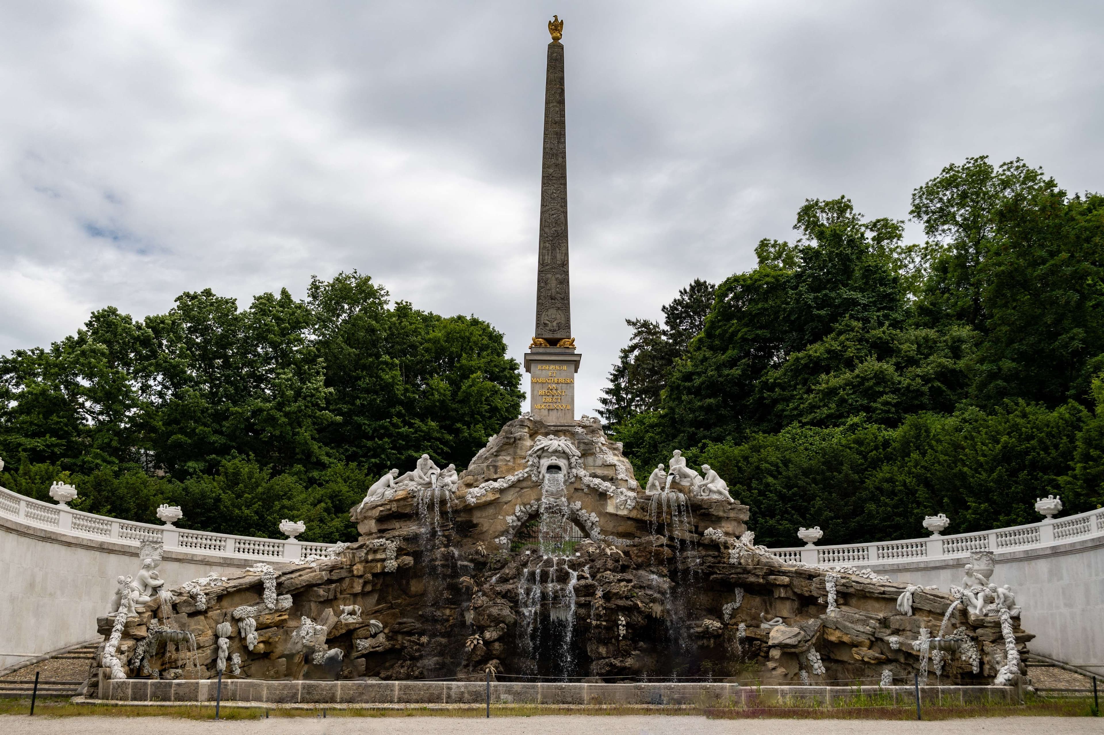 There is a fountain with a statue in the middle of it.