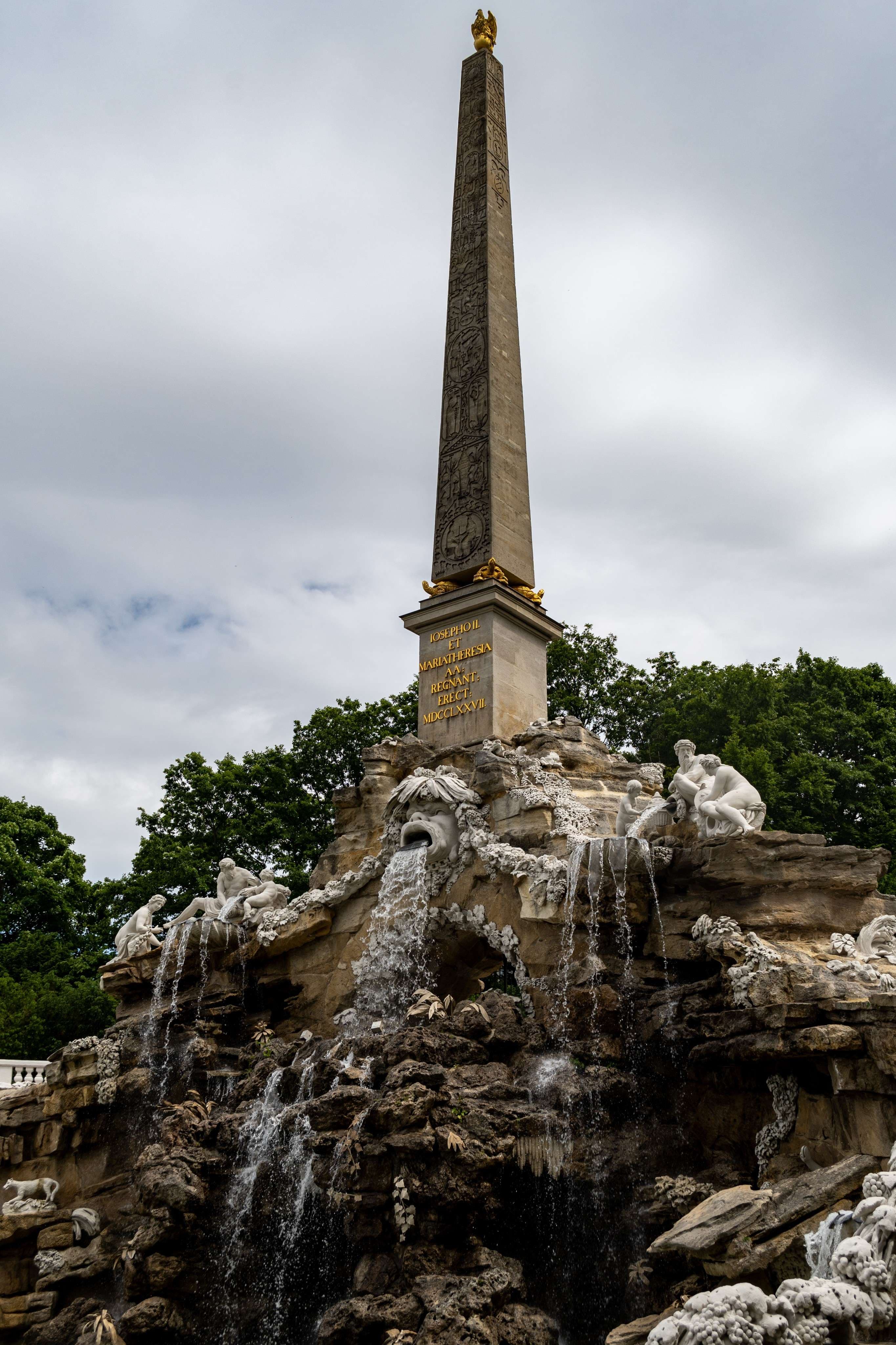 There is a statue of a man standing on top of a rock.