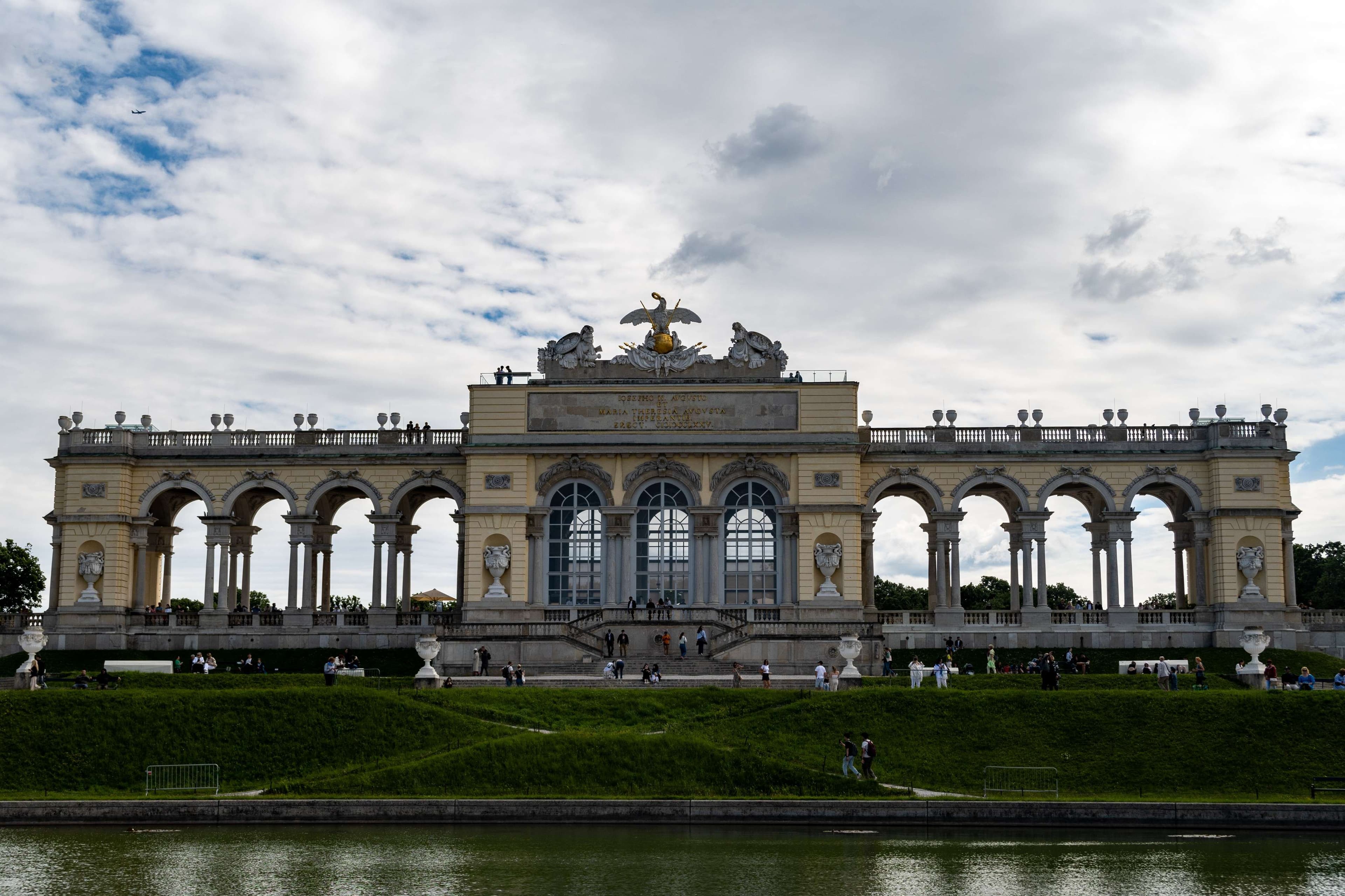 There is a large building with a fountain in front of it.