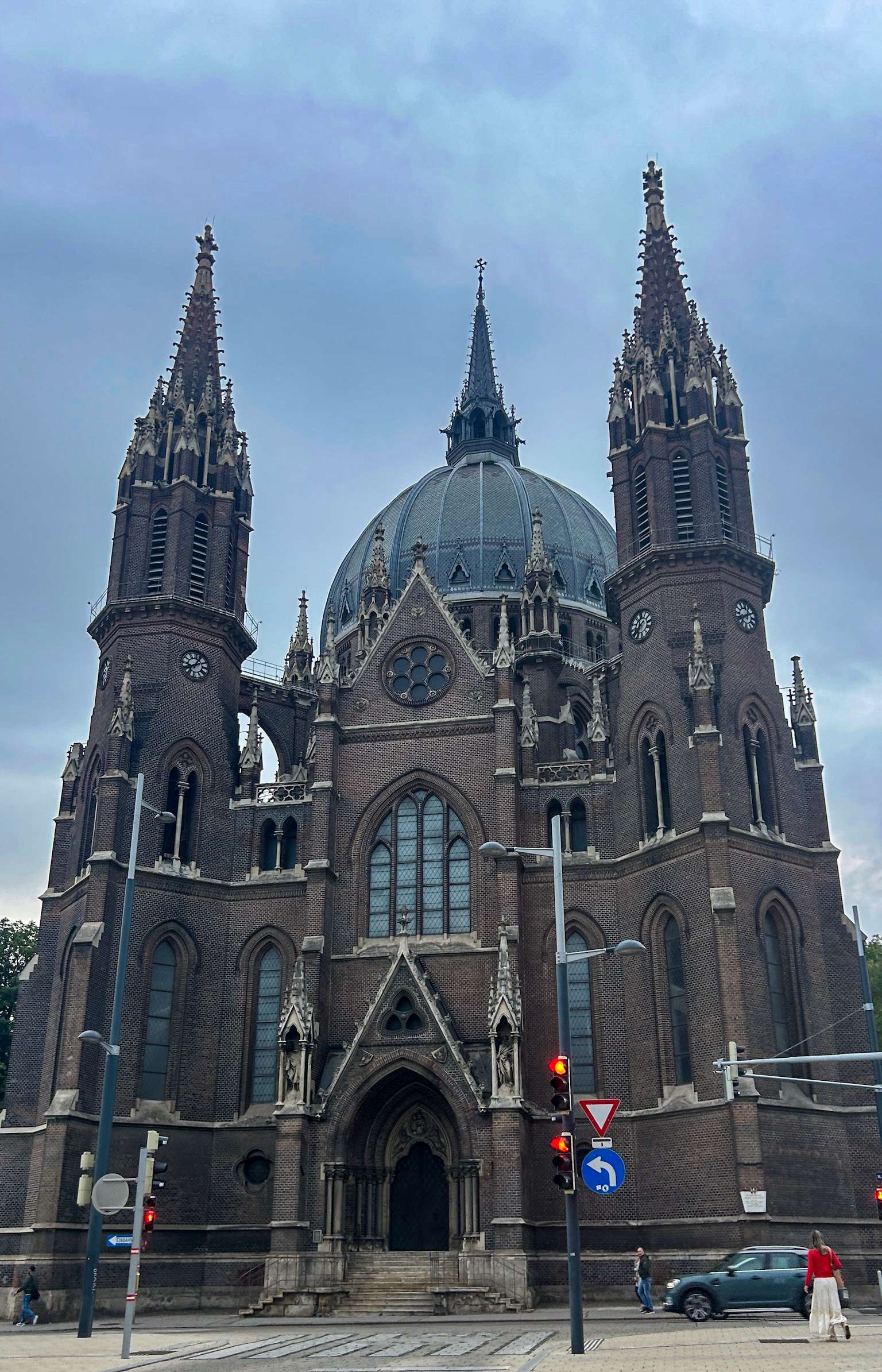 Arafed church with a clock tower and a traffic light.