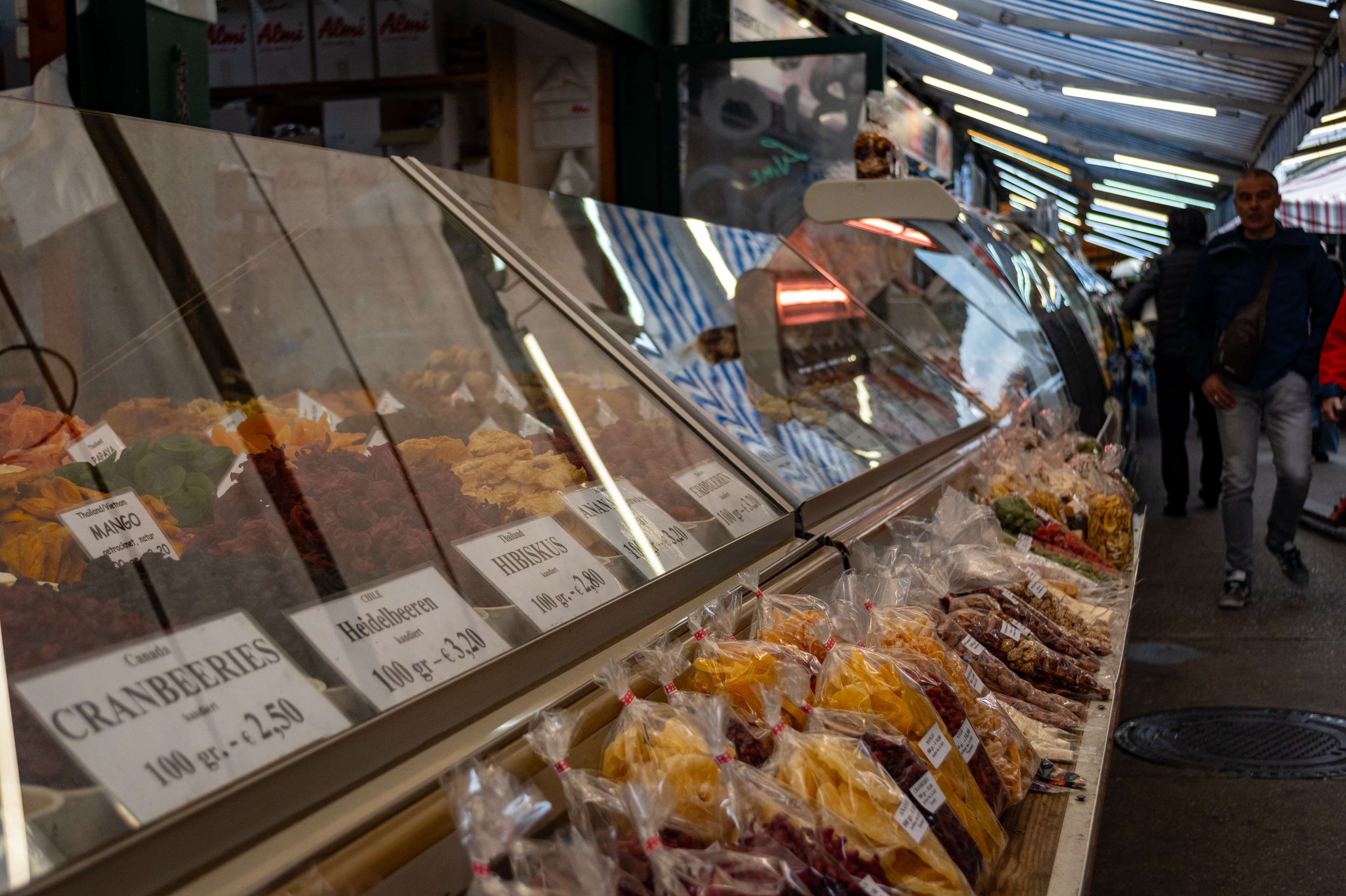 There are many different kinds of food on display in a market.