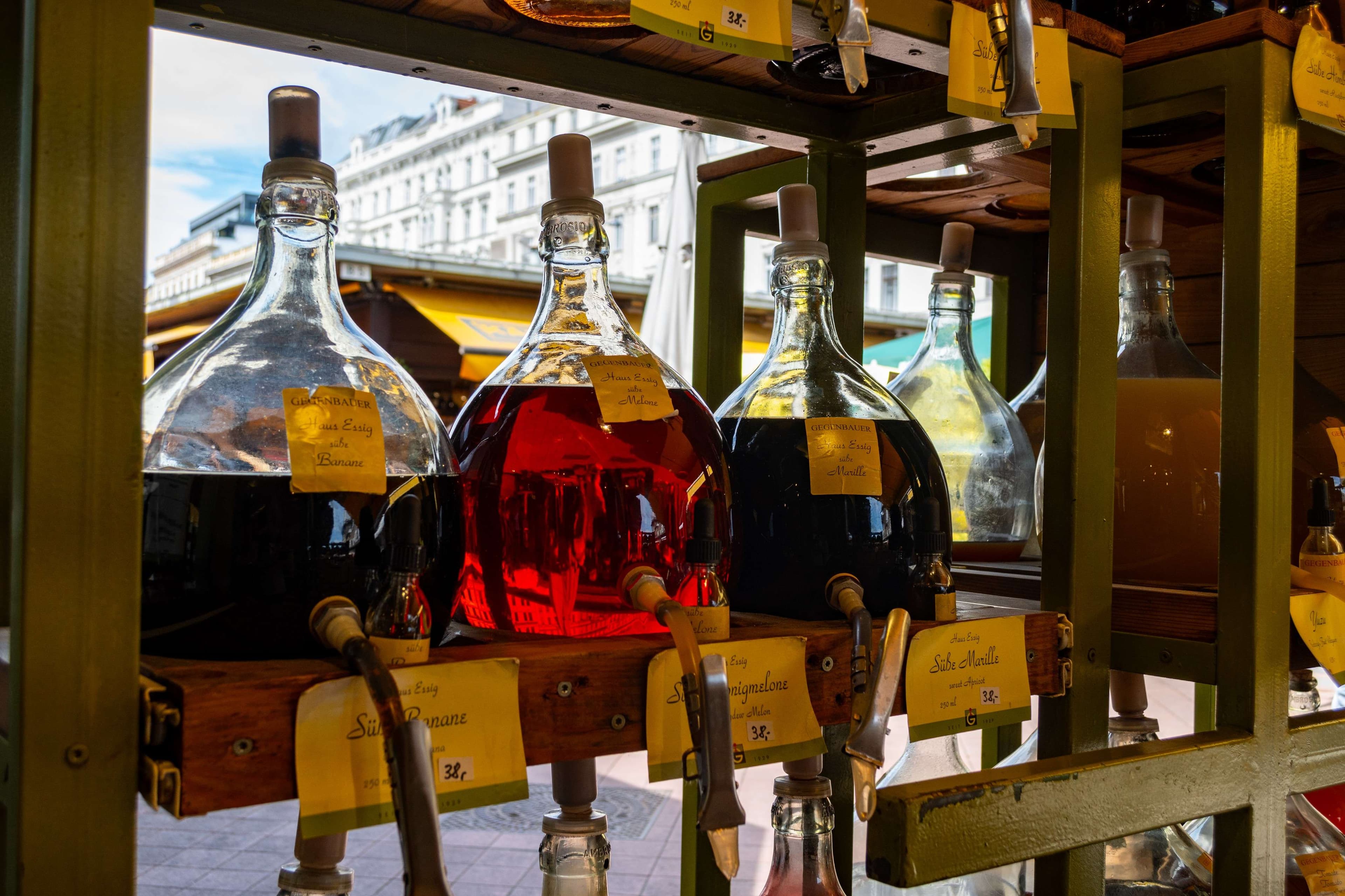 Bottles of alcohol are on display in a store window.