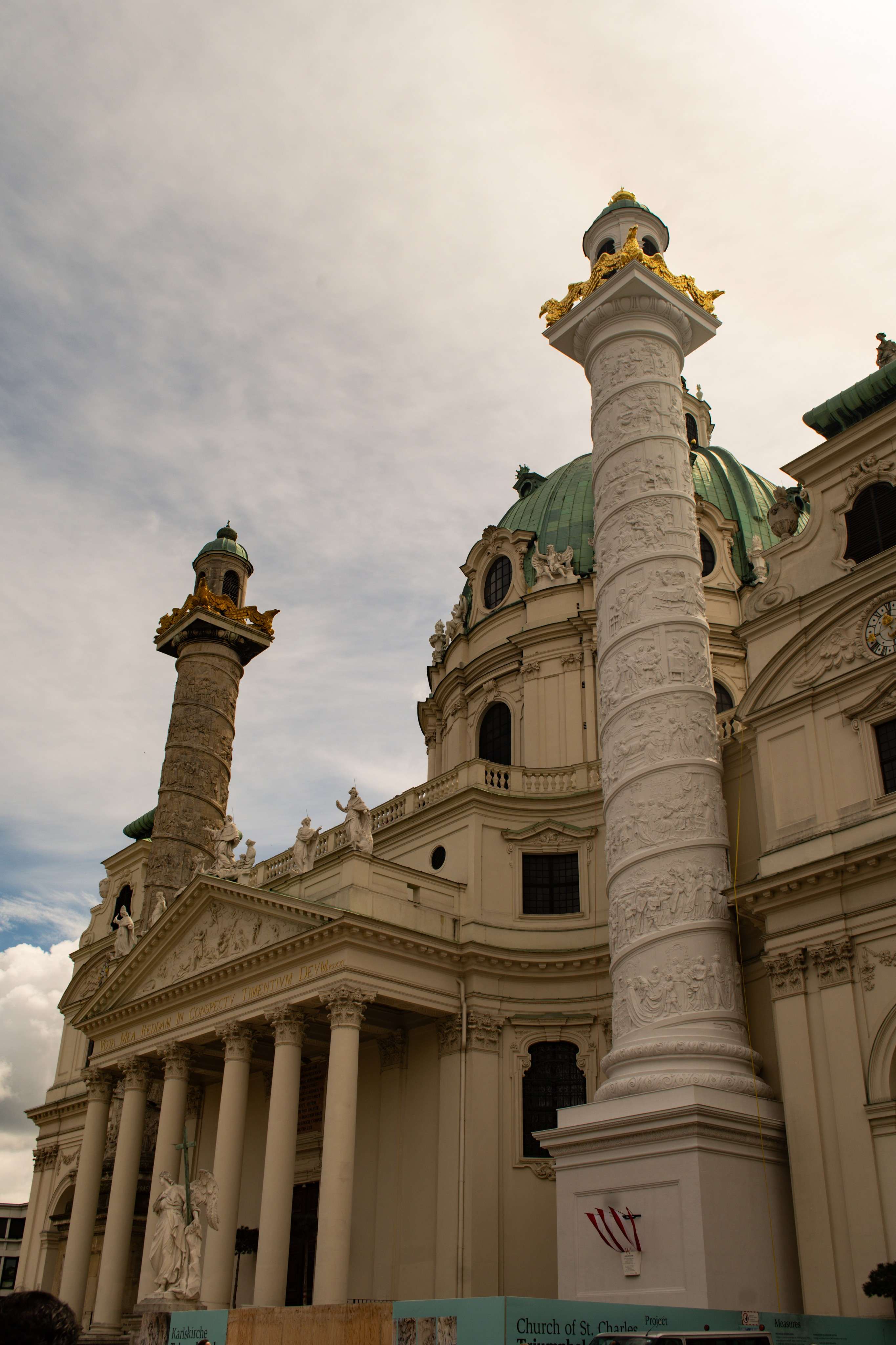 There is a large building with a clock tower in front of it.