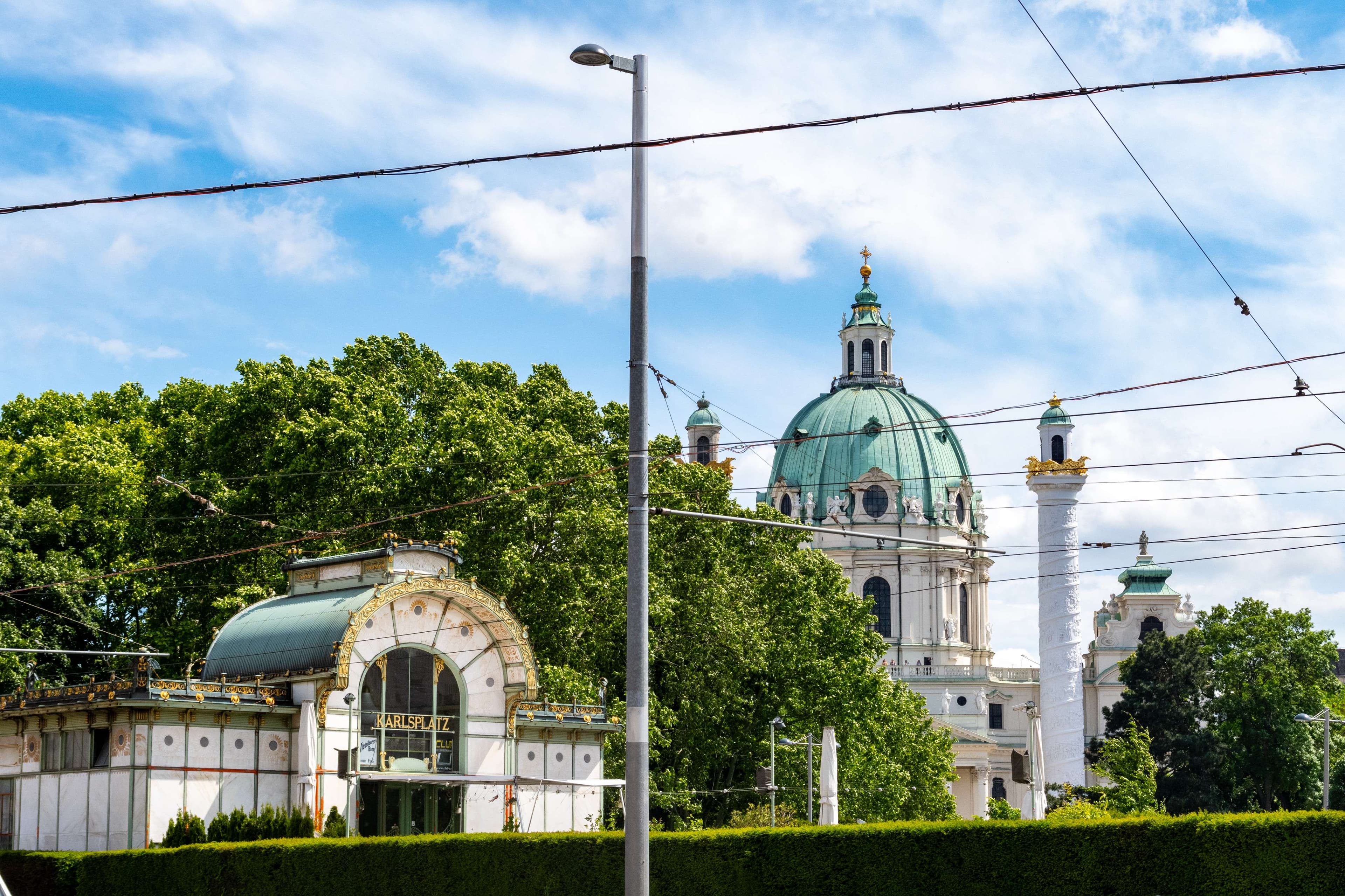 There is a large building with a green dome on top of it.