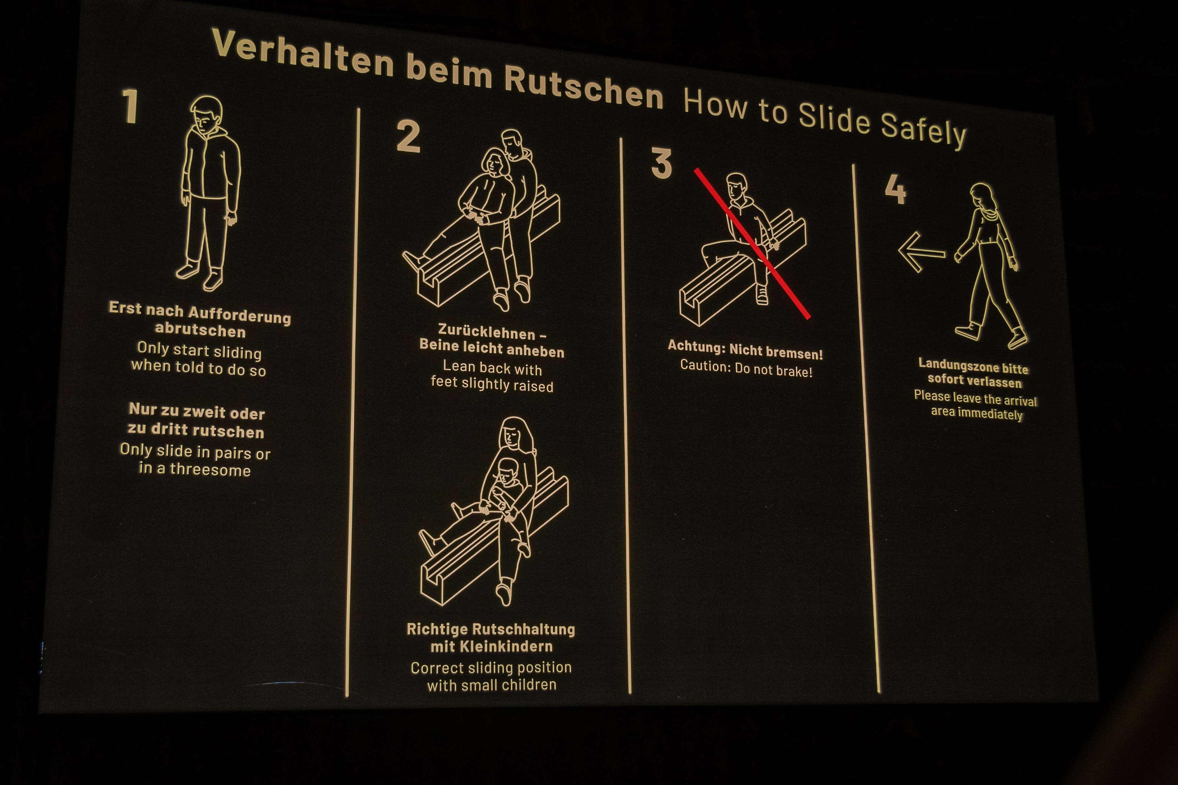 Arafed sign showing instructions to use a slide safety device.