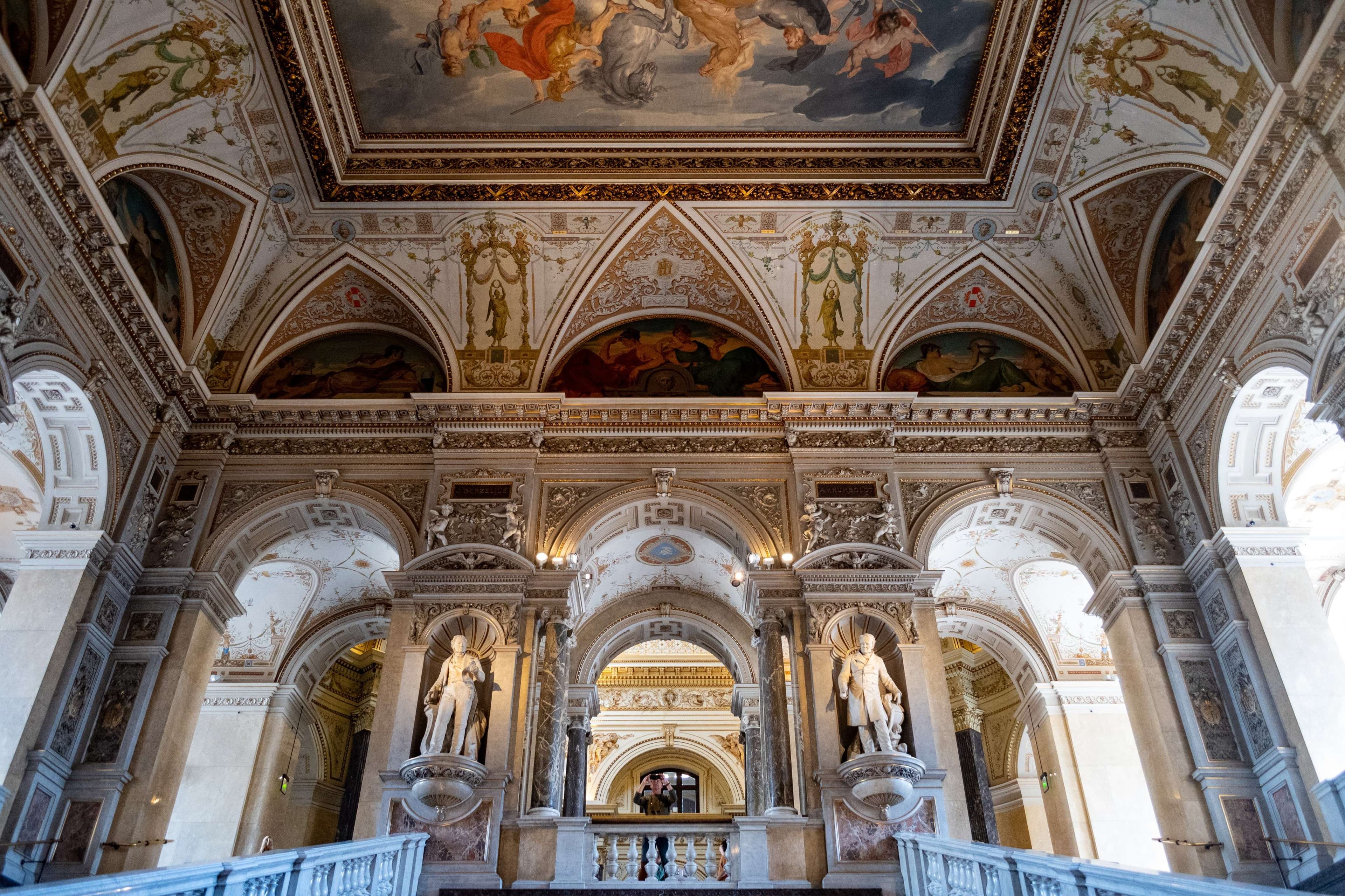 There is a large room with a ceiling painted with a painting.