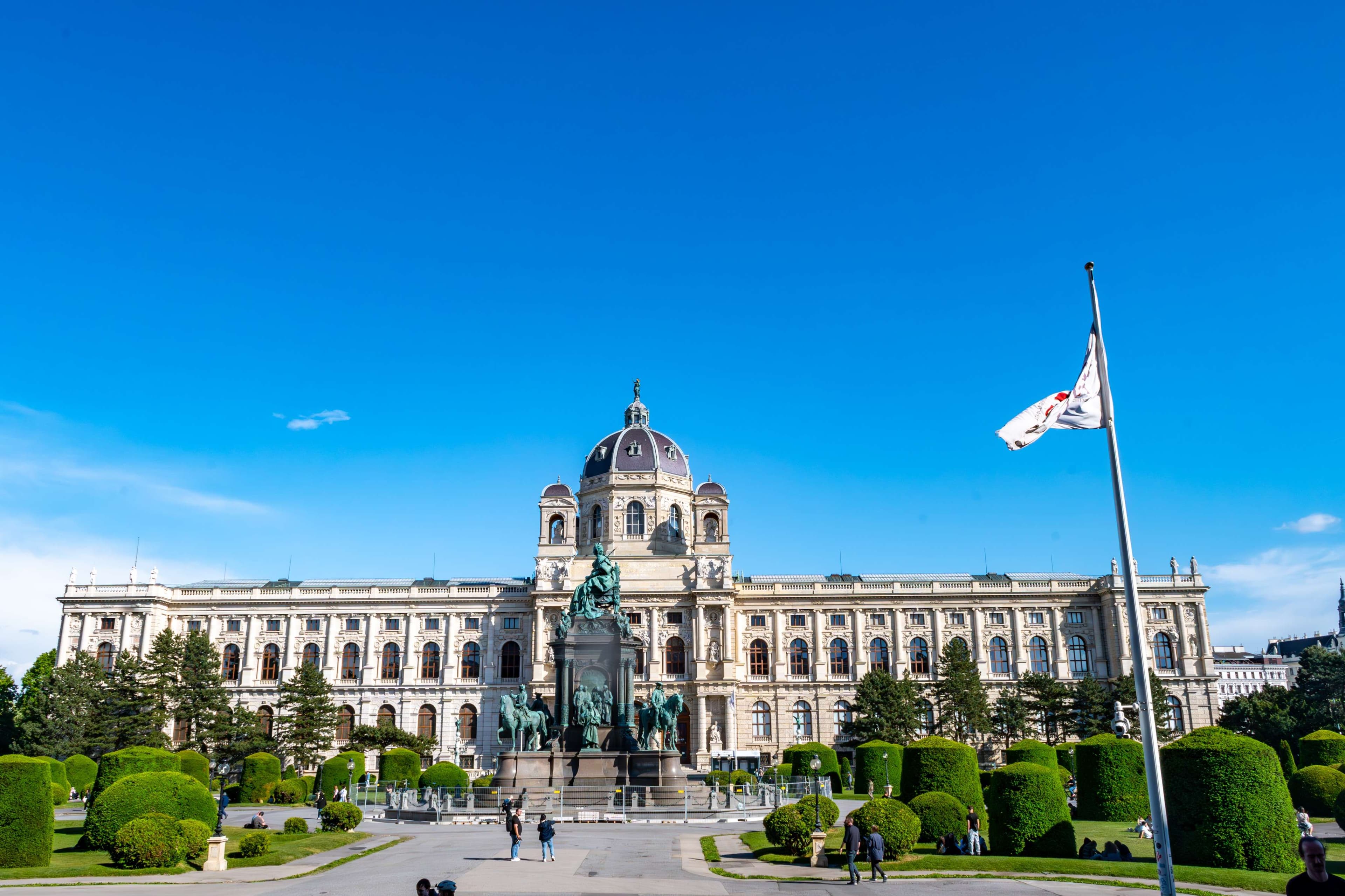 Arafed view of a large building with a statue in front of it.
