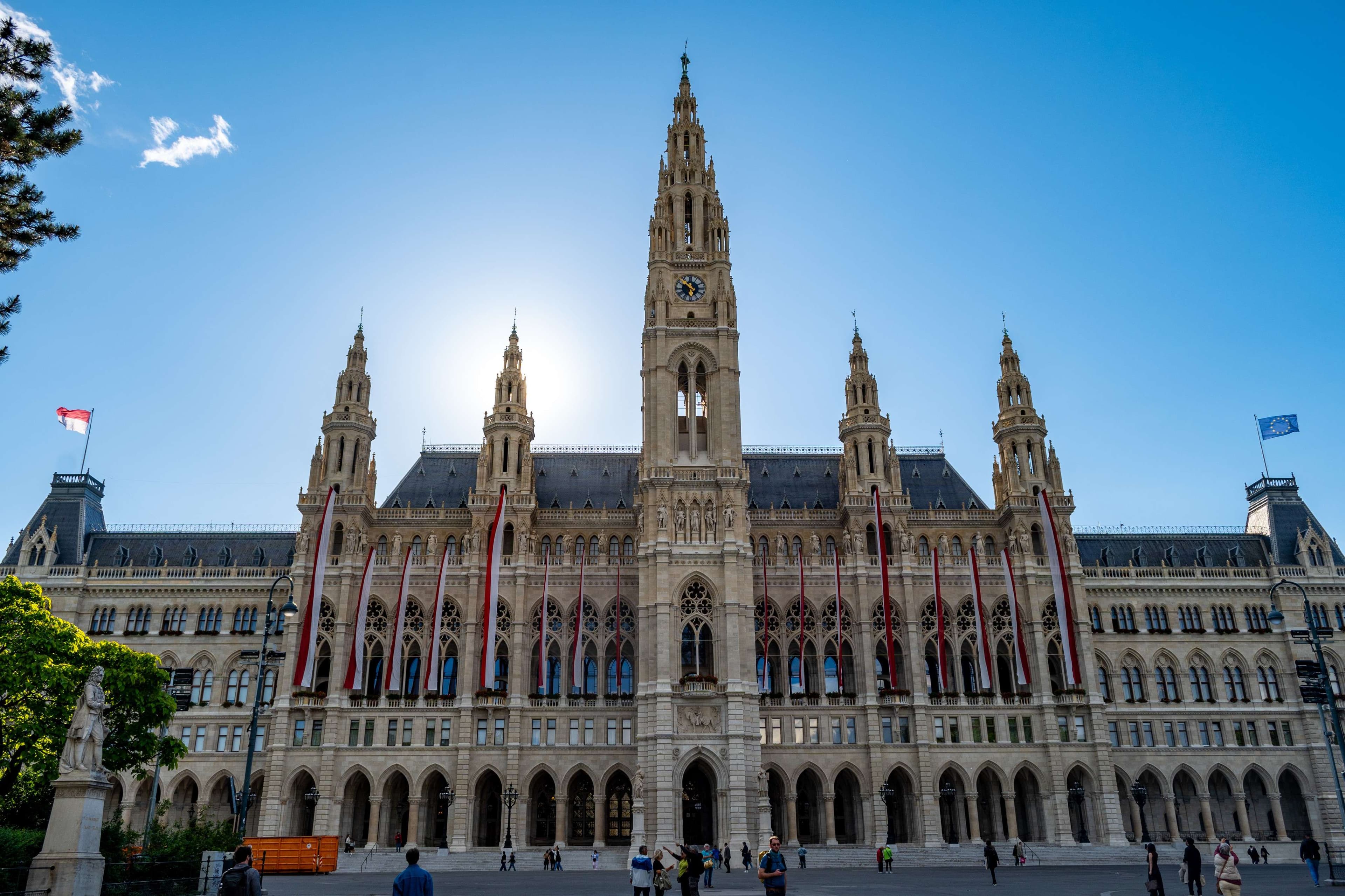 Araful looking building with a clock tower and a lot of people.