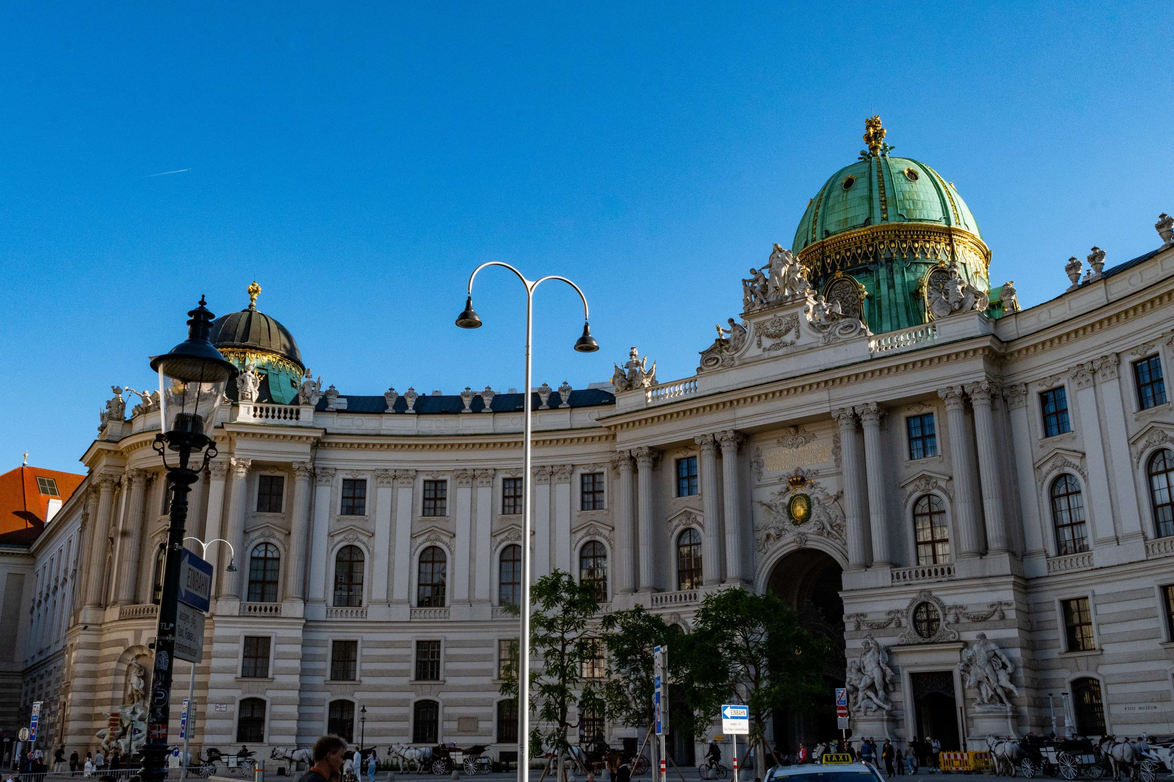 There is a large building with a green dome on top.