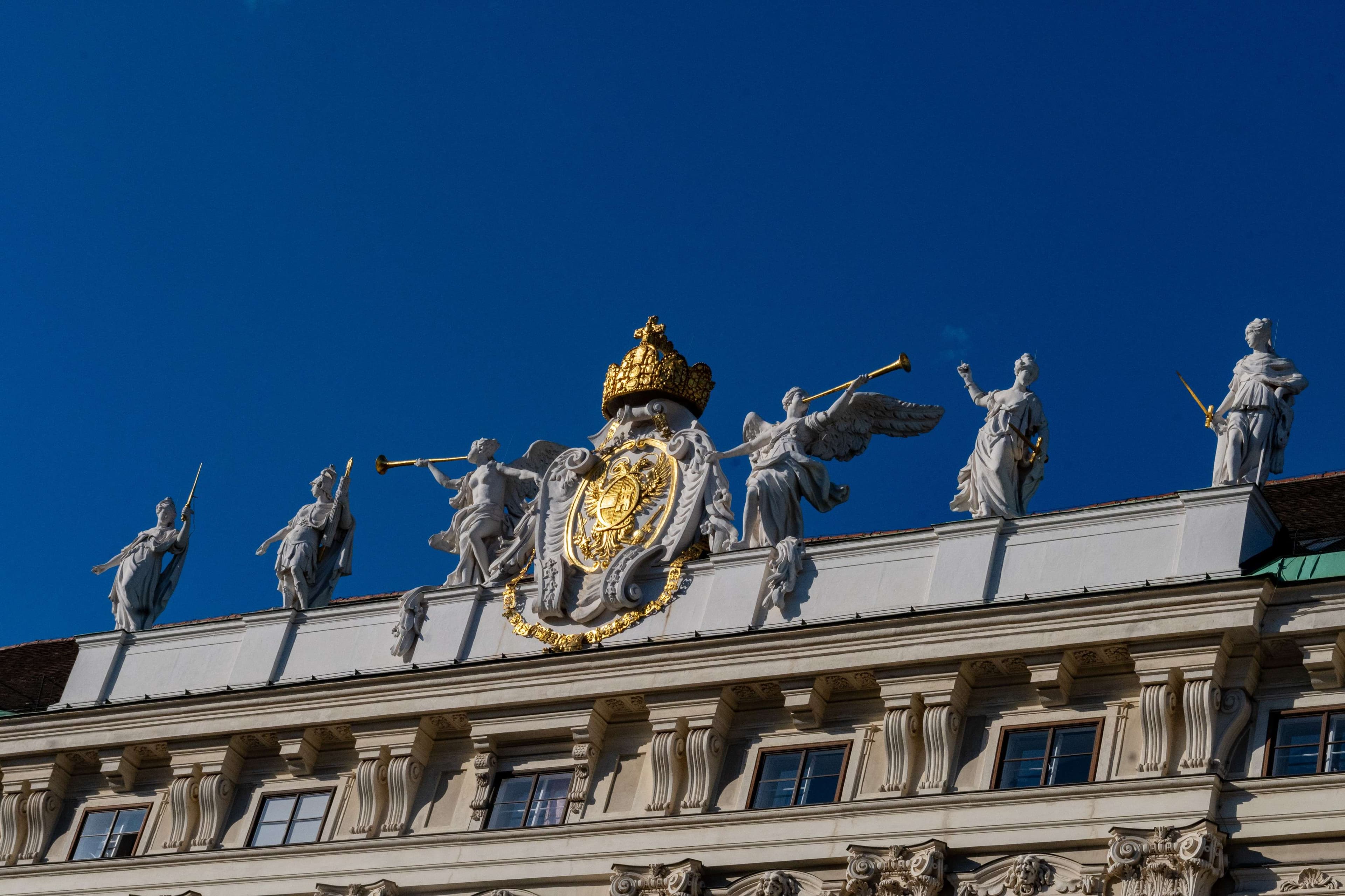 There is a large building with statues on top of it.
