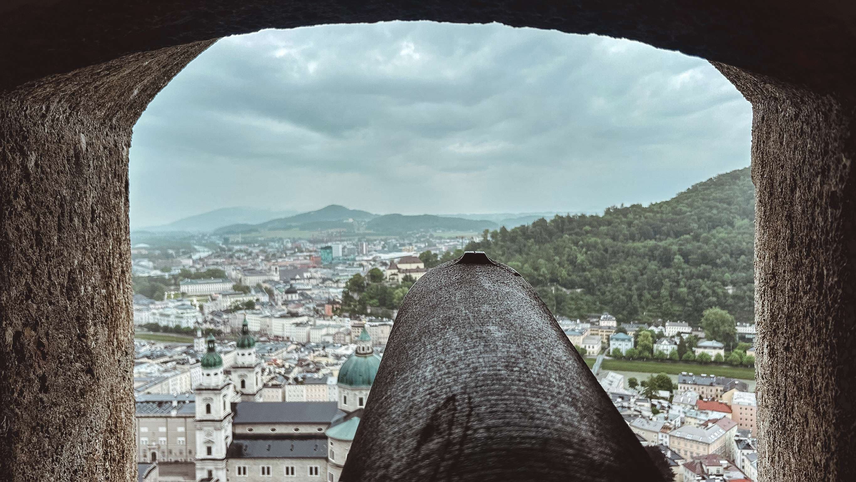 Arafed view of a city from a window of a castle.