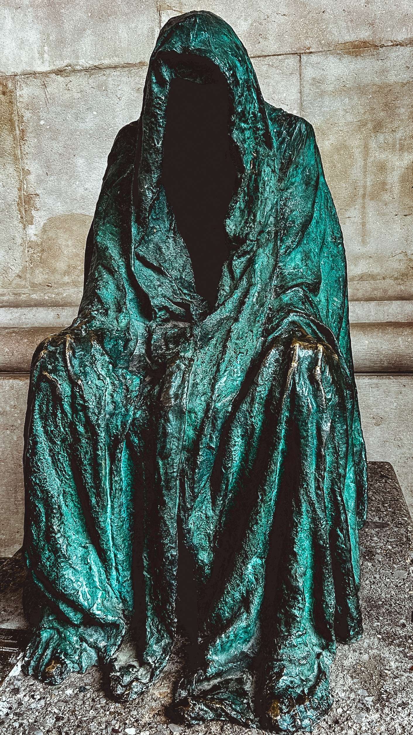 Arafed statue of a person sitting on a stone bench.