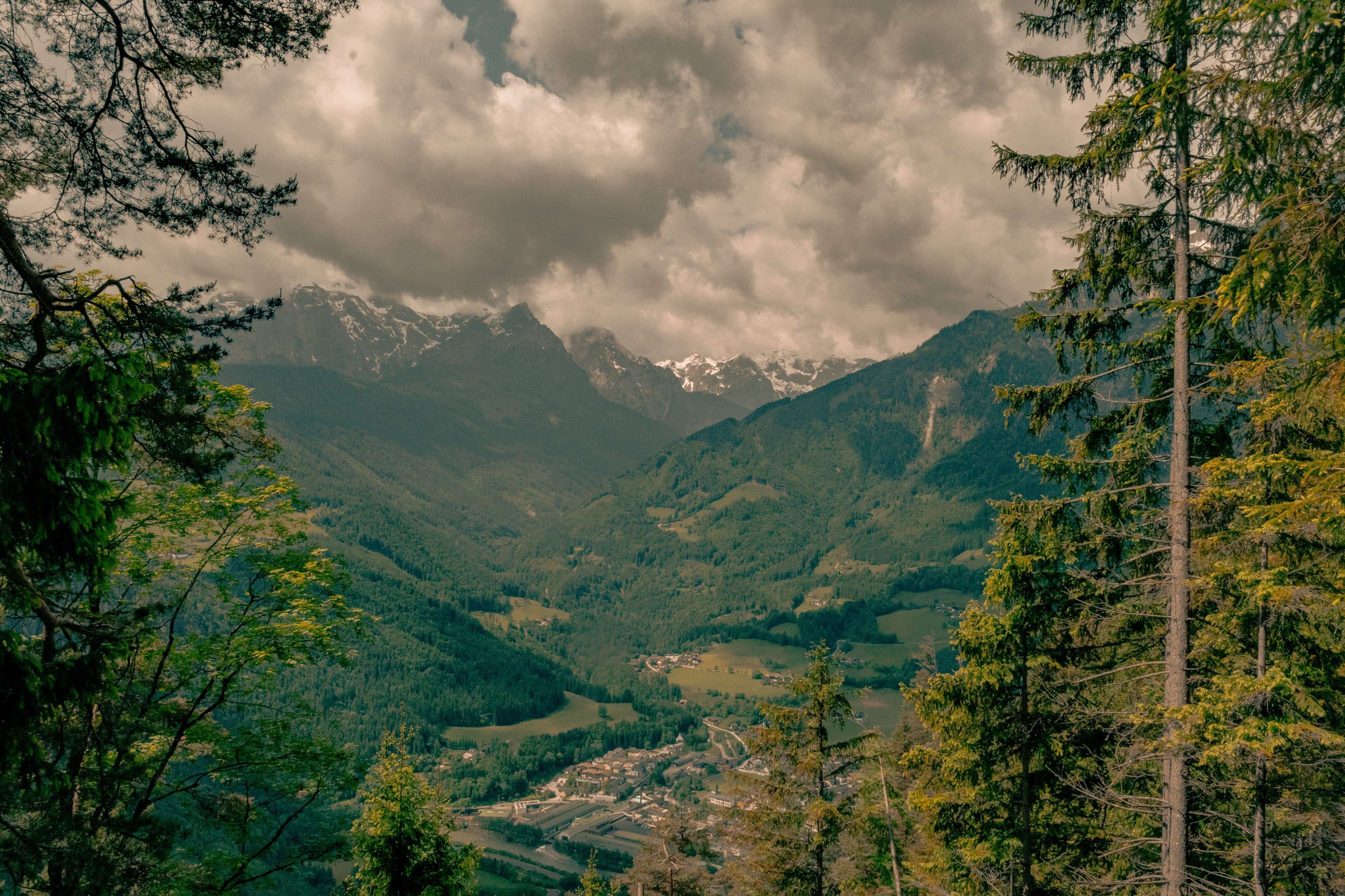 Mountains and valleys with a small town in the distance.