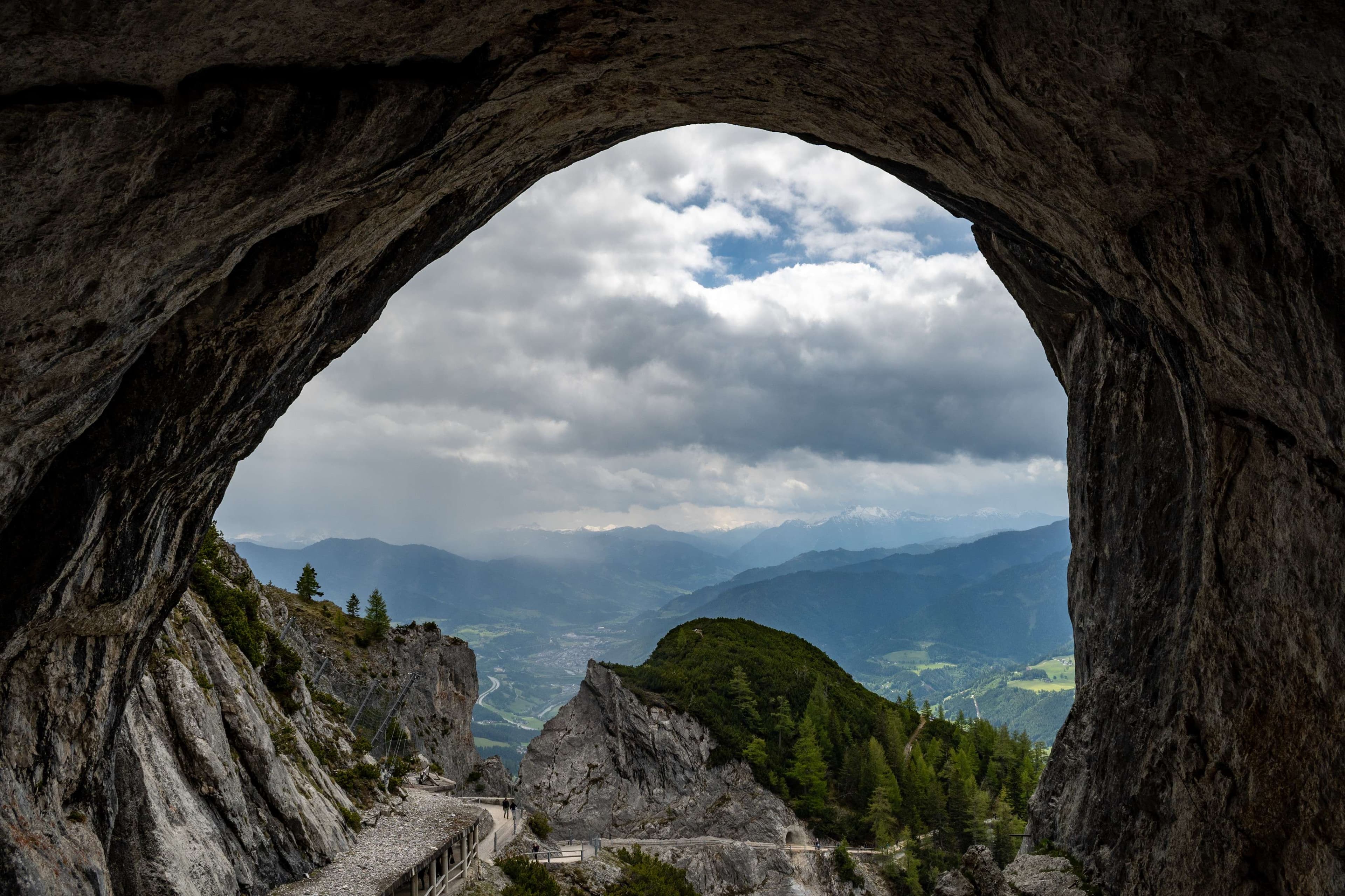 There is a view of a mountain from a cave.