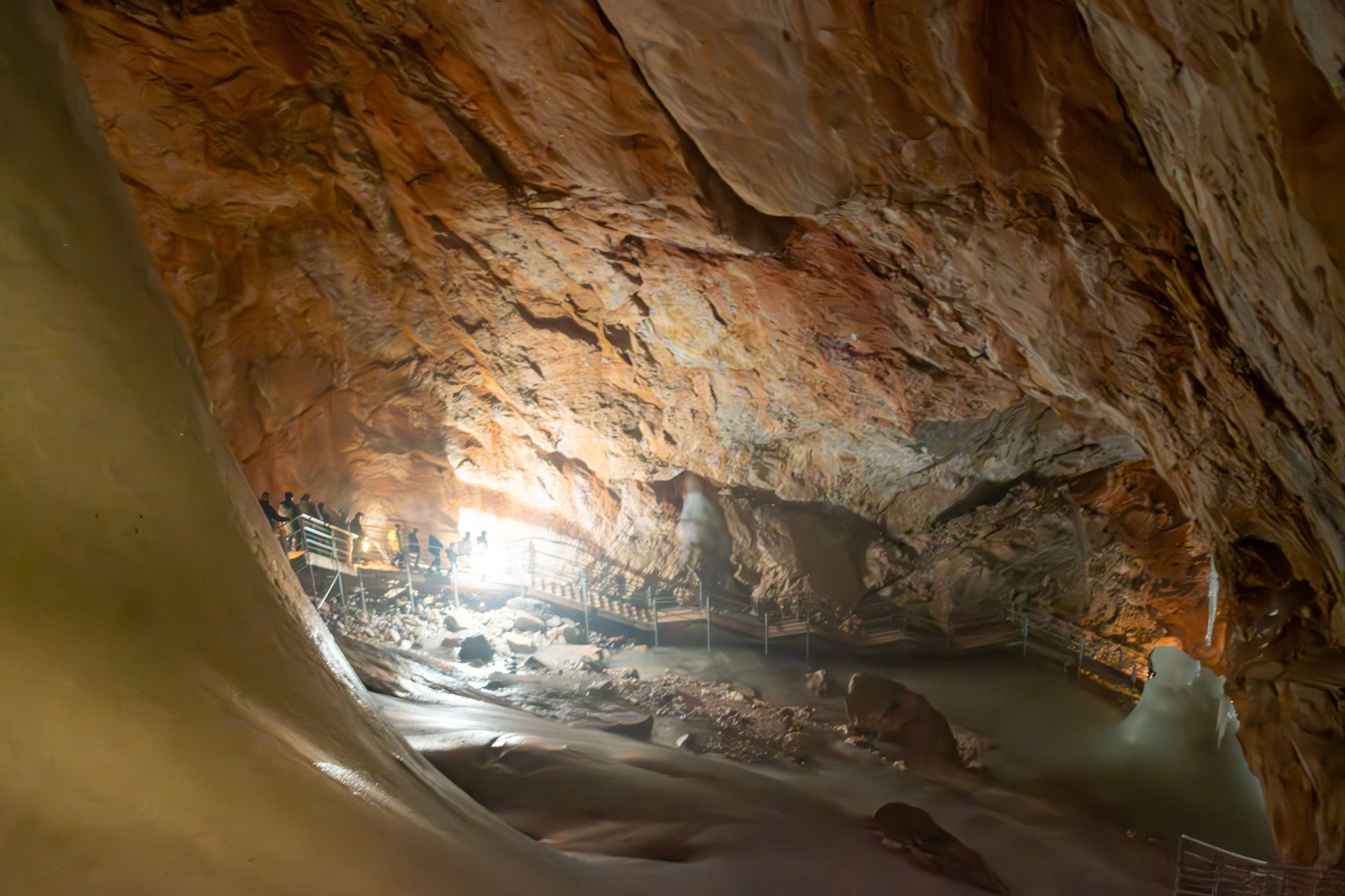 There is a cave with a stream running through it.