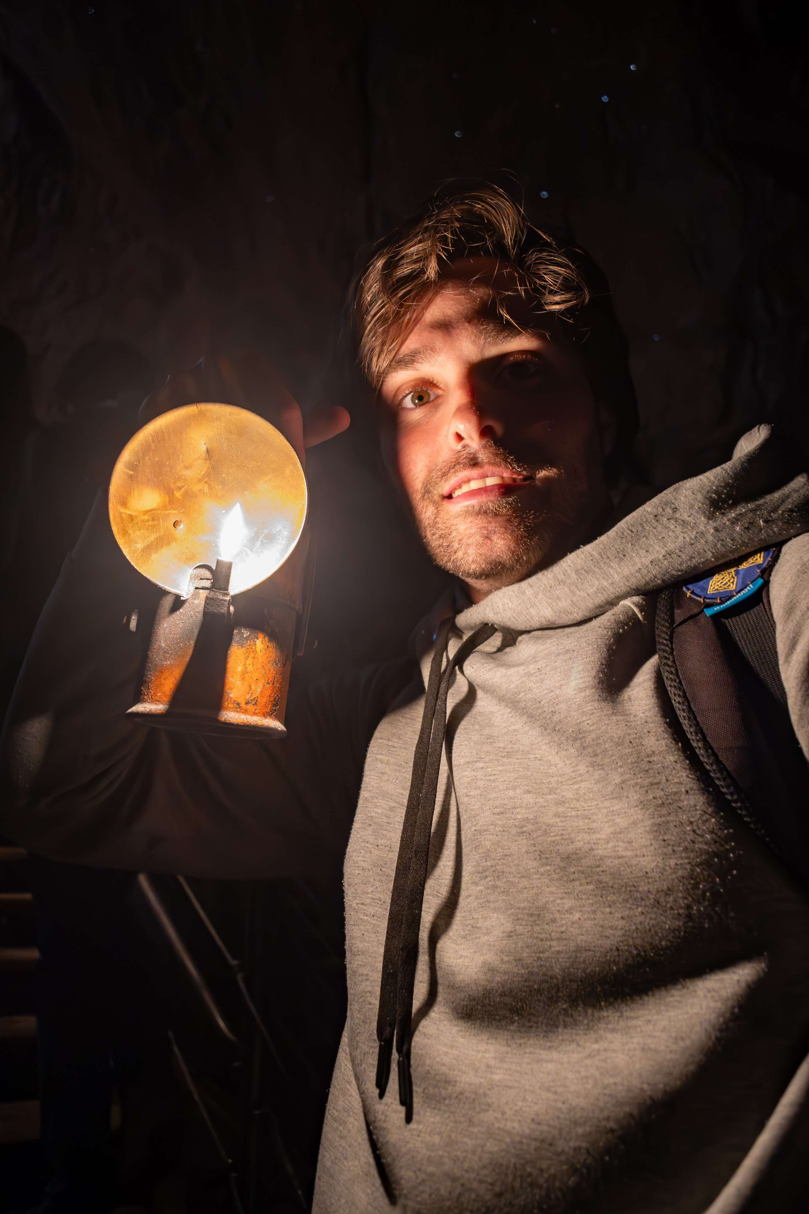 There is a man holding a light in his hand.