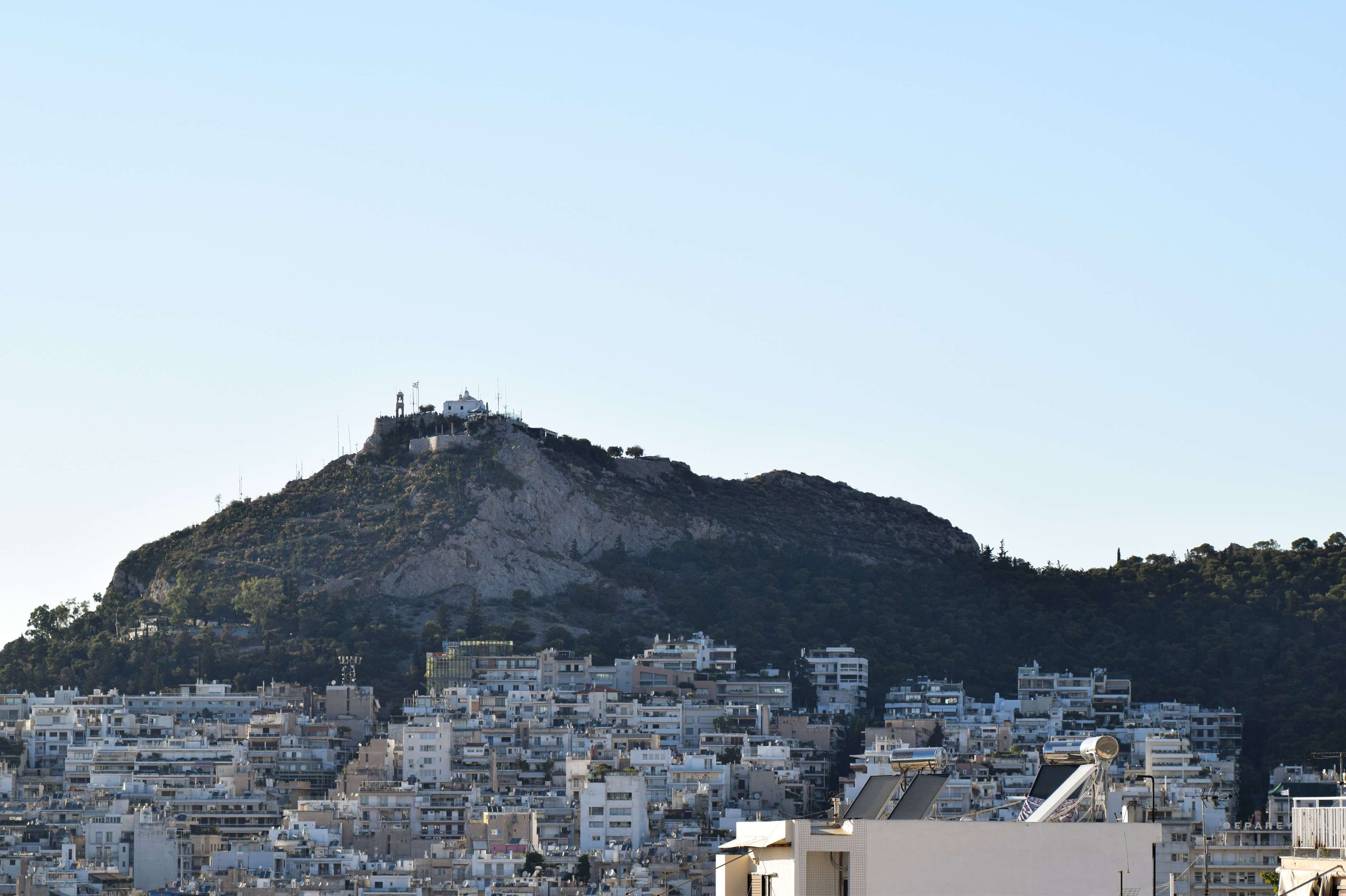 Mountains in the background with a city on top of them.