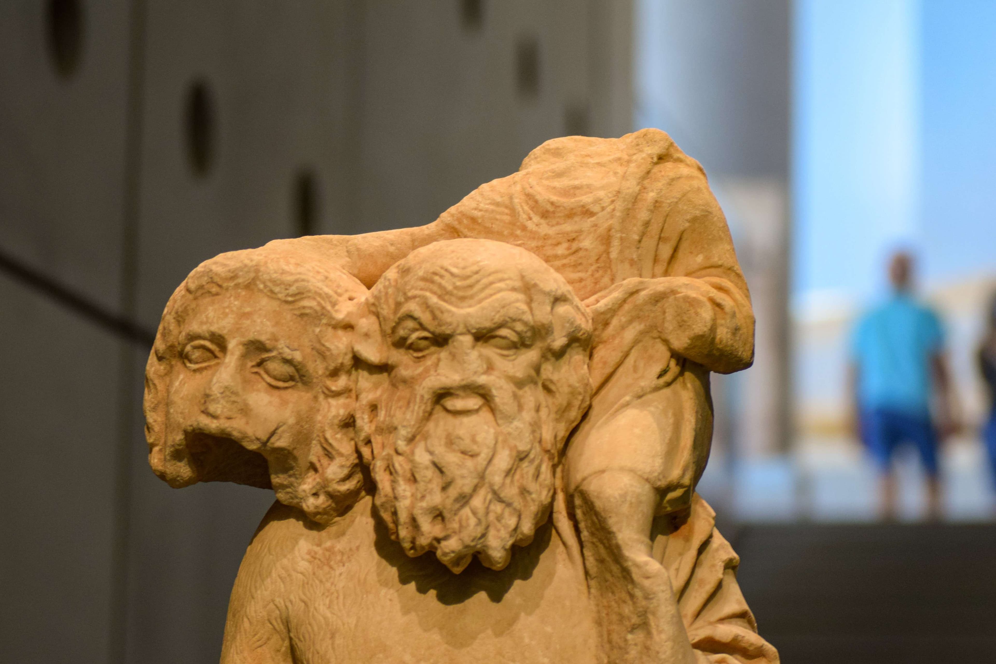 There is a statue of a man carrying a sheep on his back.