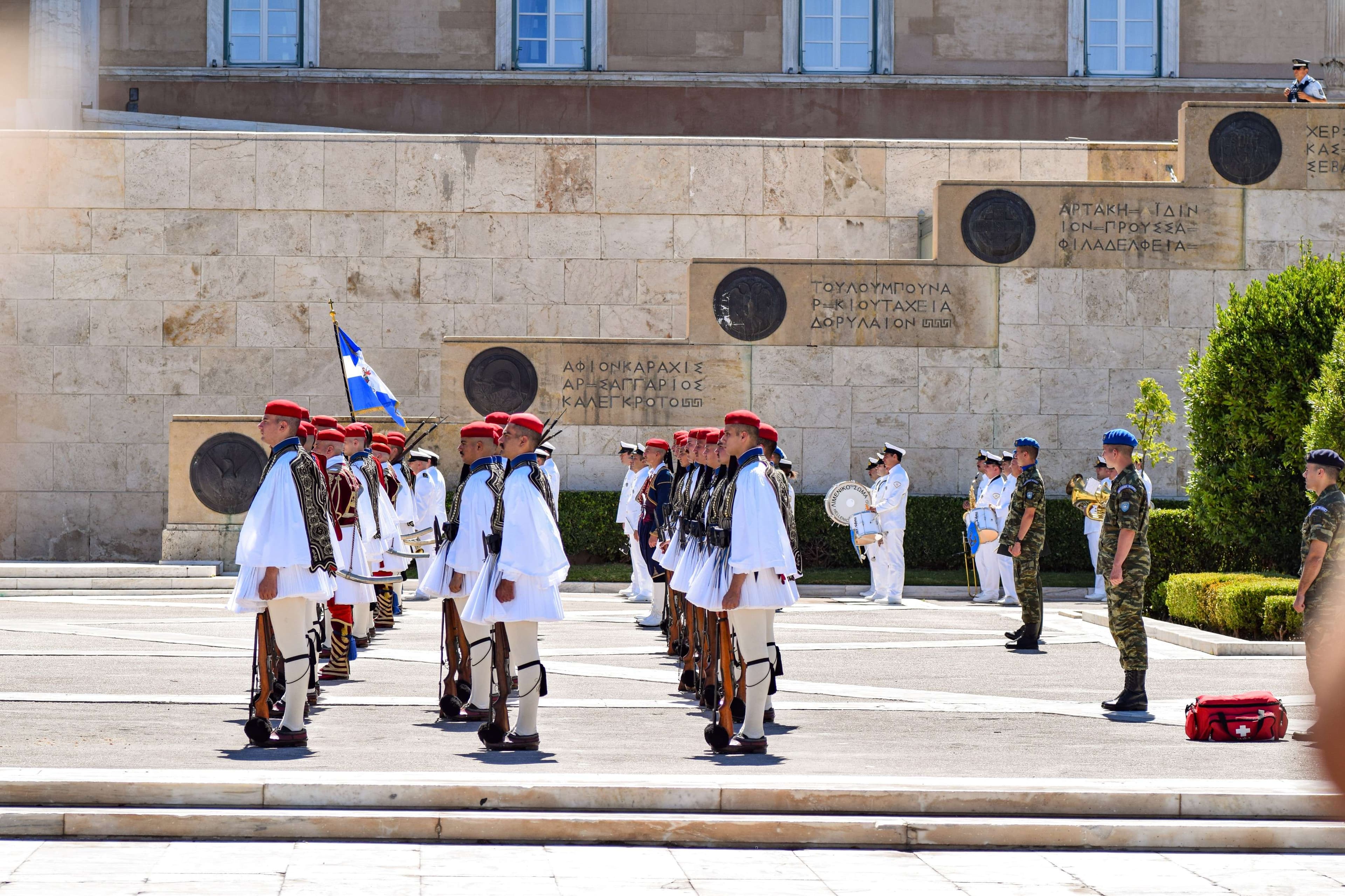 There are many men in uniform standing in a line.