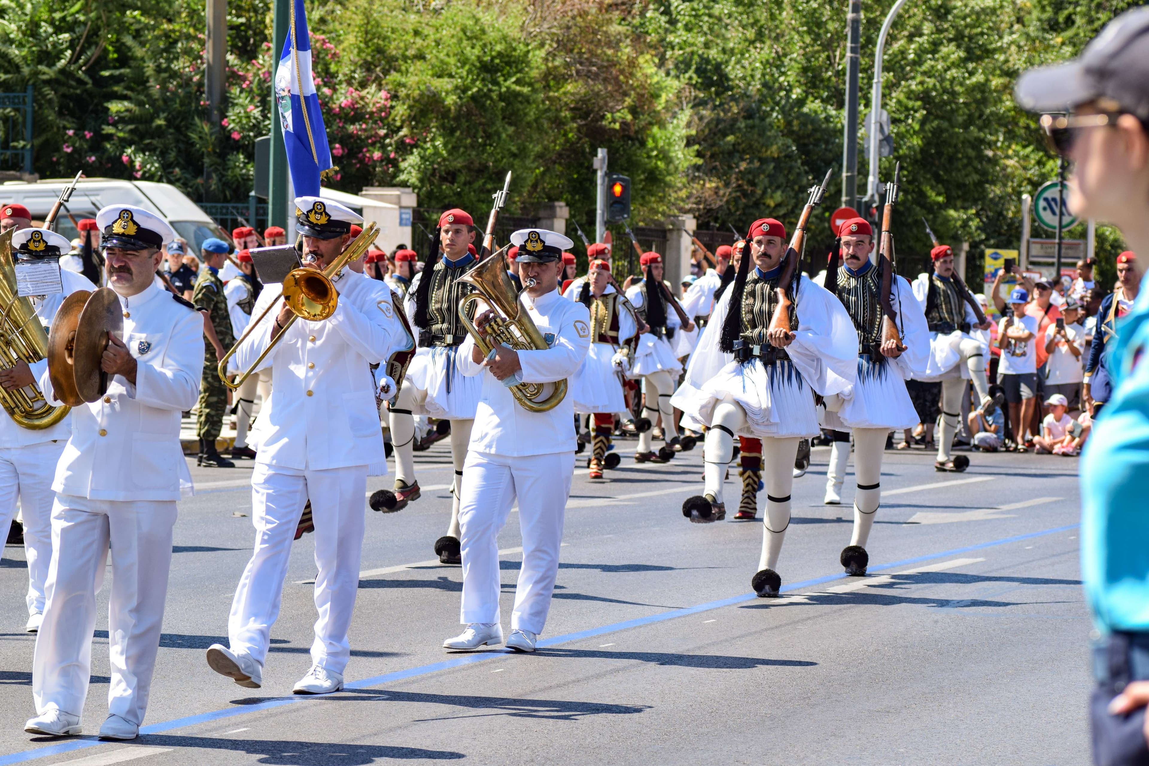 There are many people in the parade marching with instruments.
