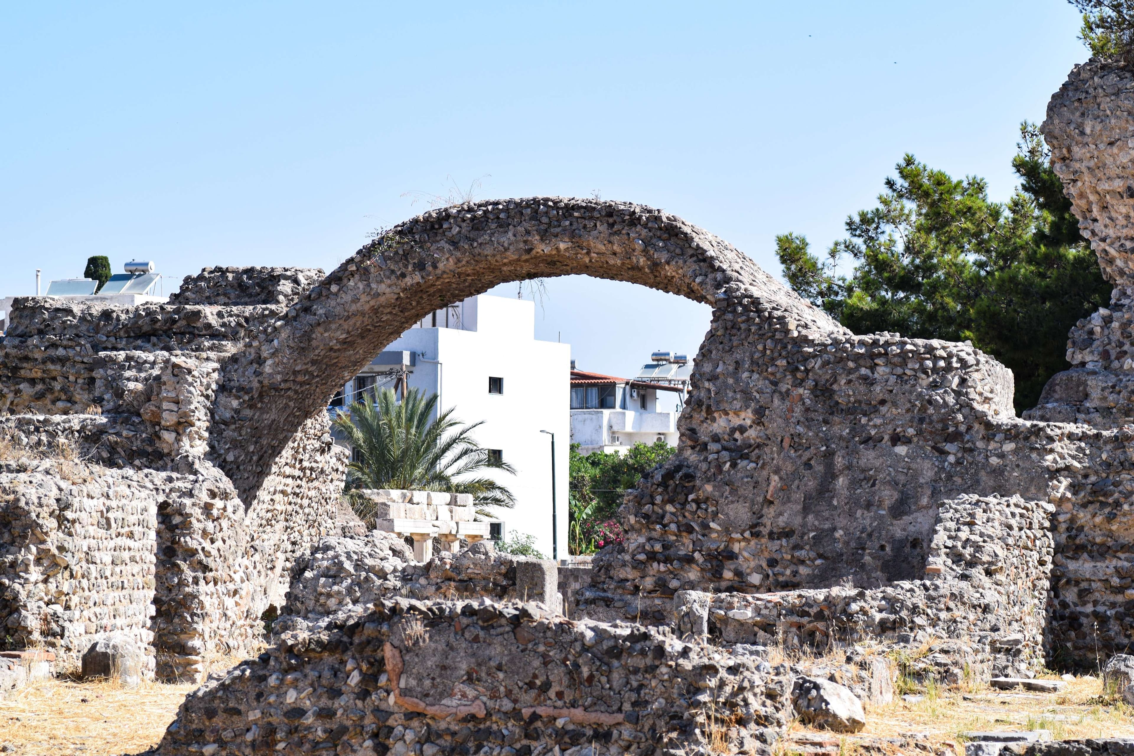 There is a stone archway in the middle of a building.