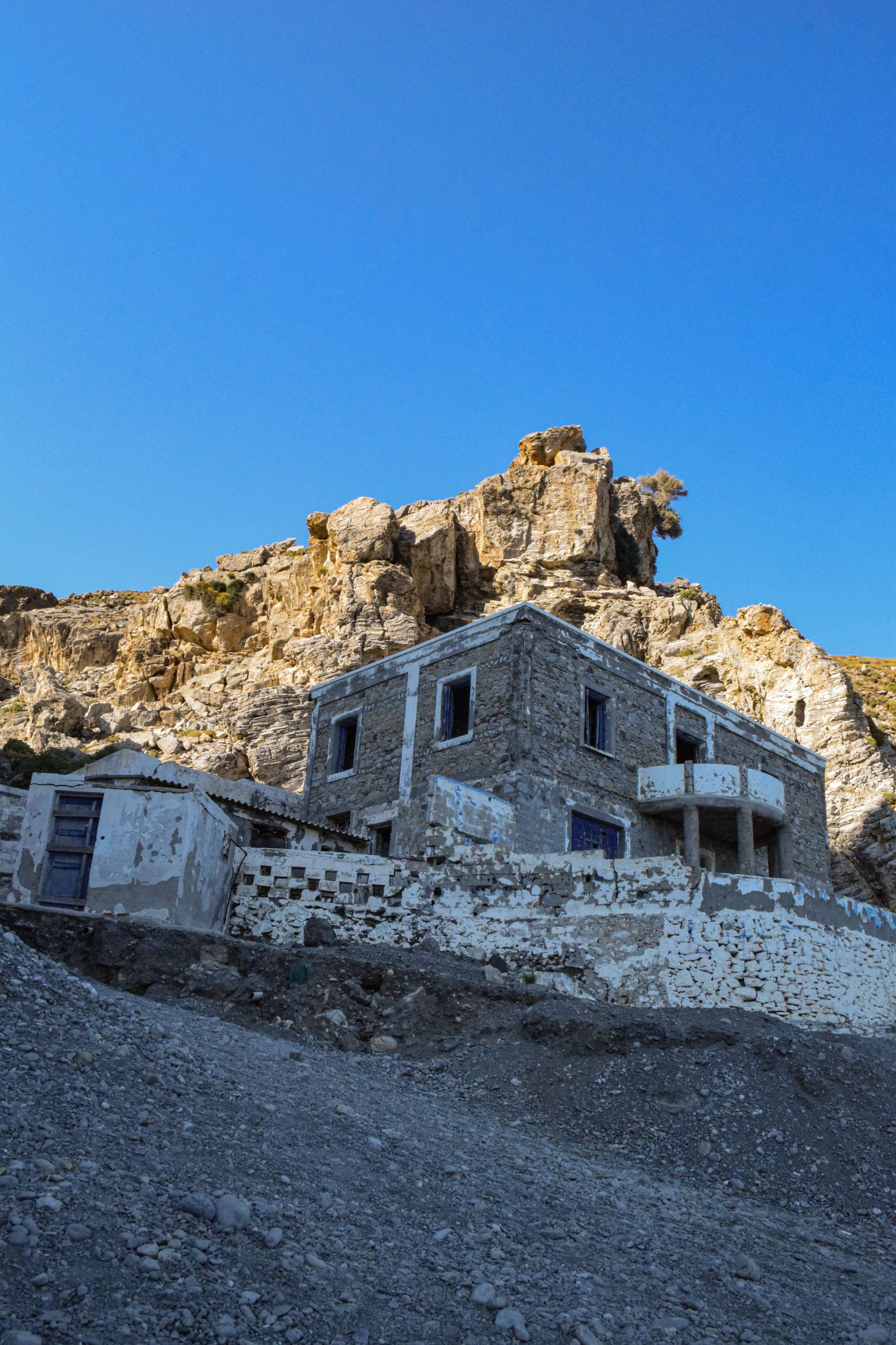 There is a building that is built into the side of a mountain.