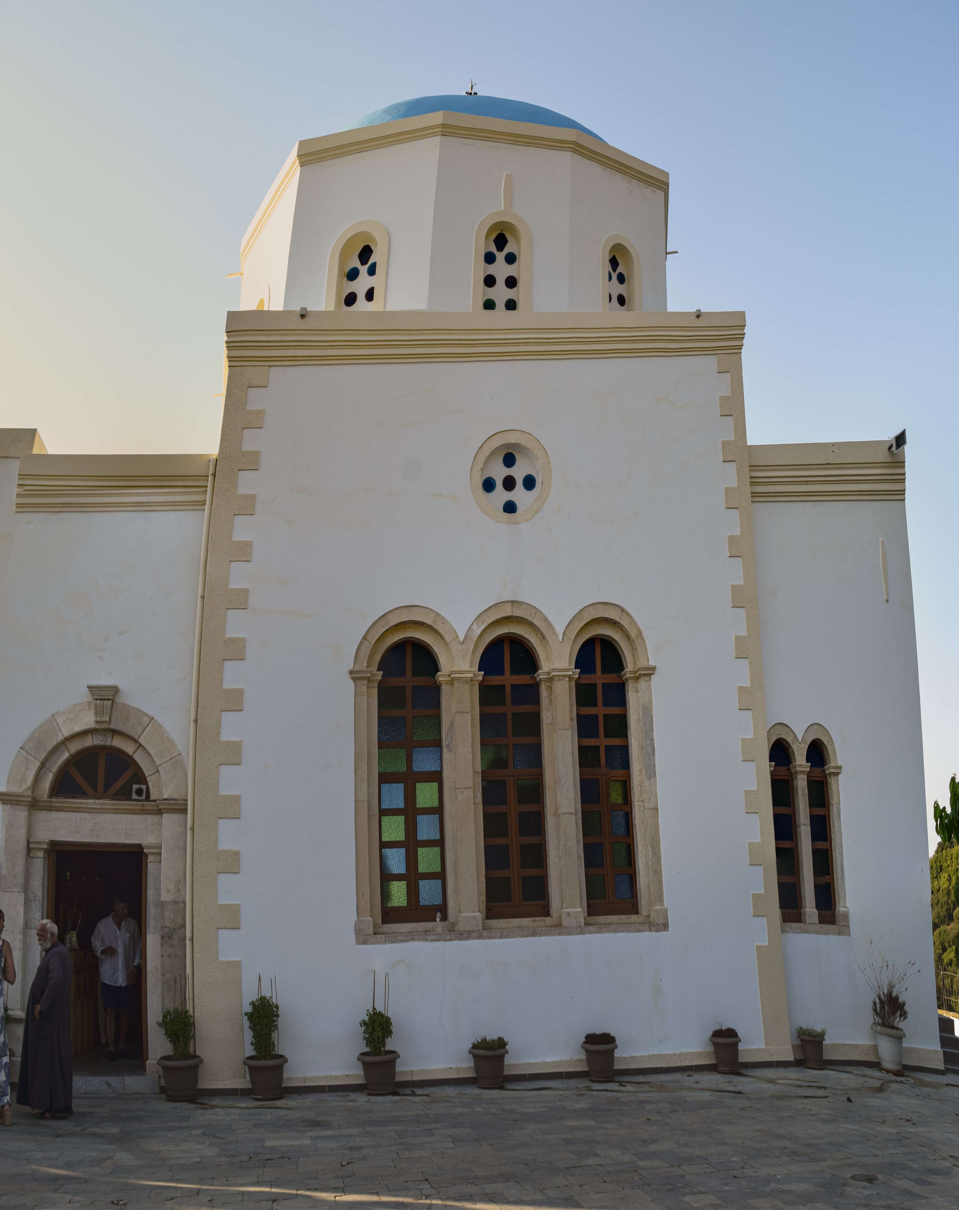 There is a man and woman standing outside of a church.