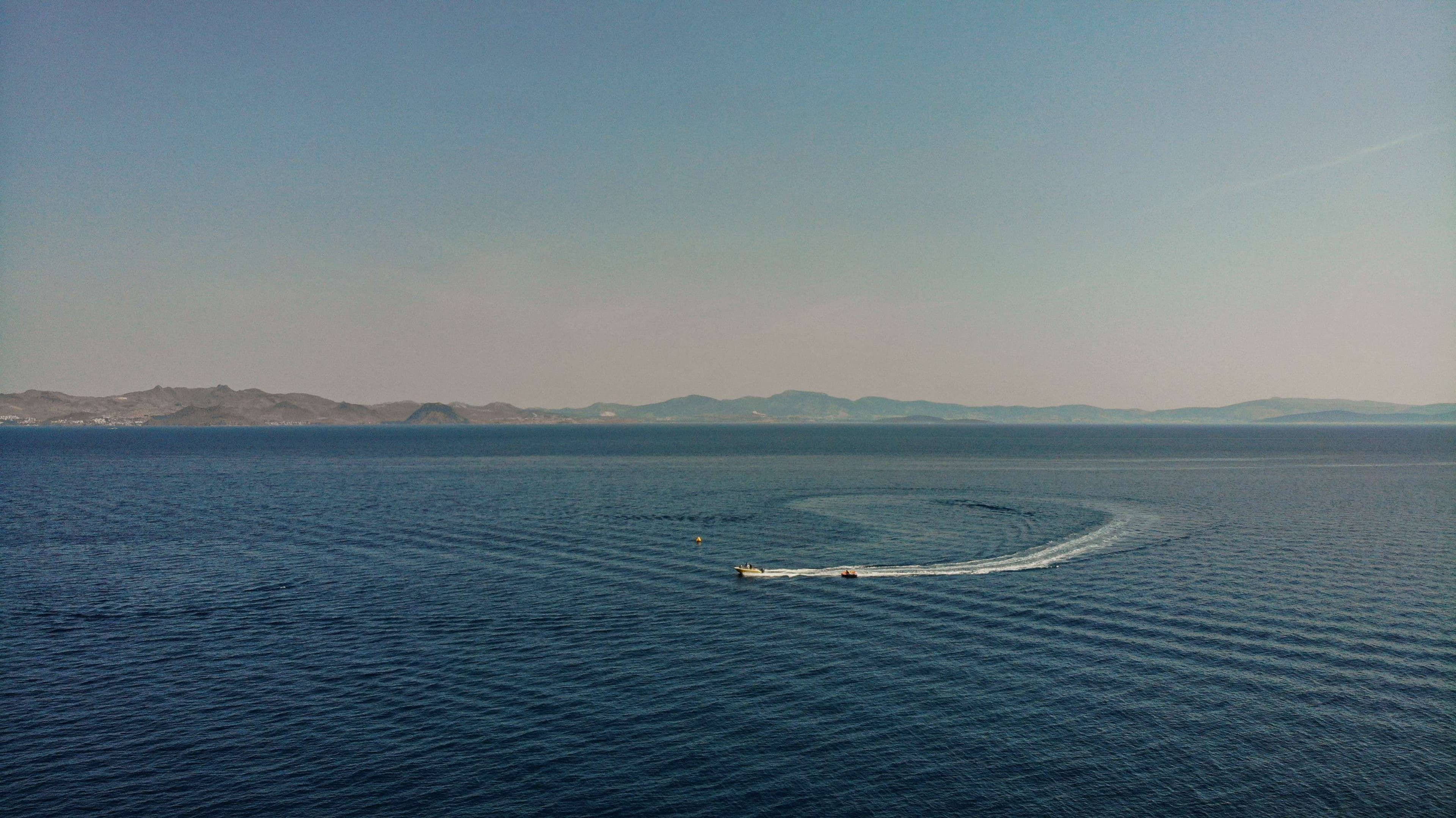 There is a small boat that is traveling in the water.