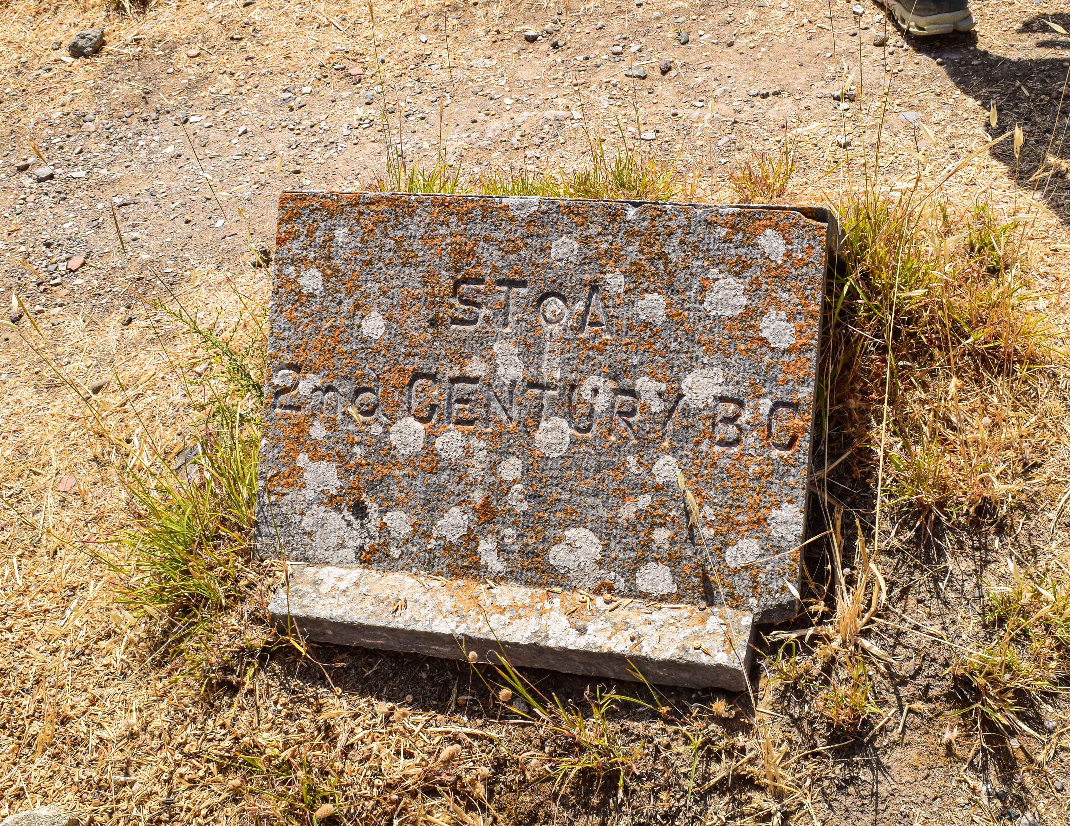 There is a stone with a sign that says to be loved.