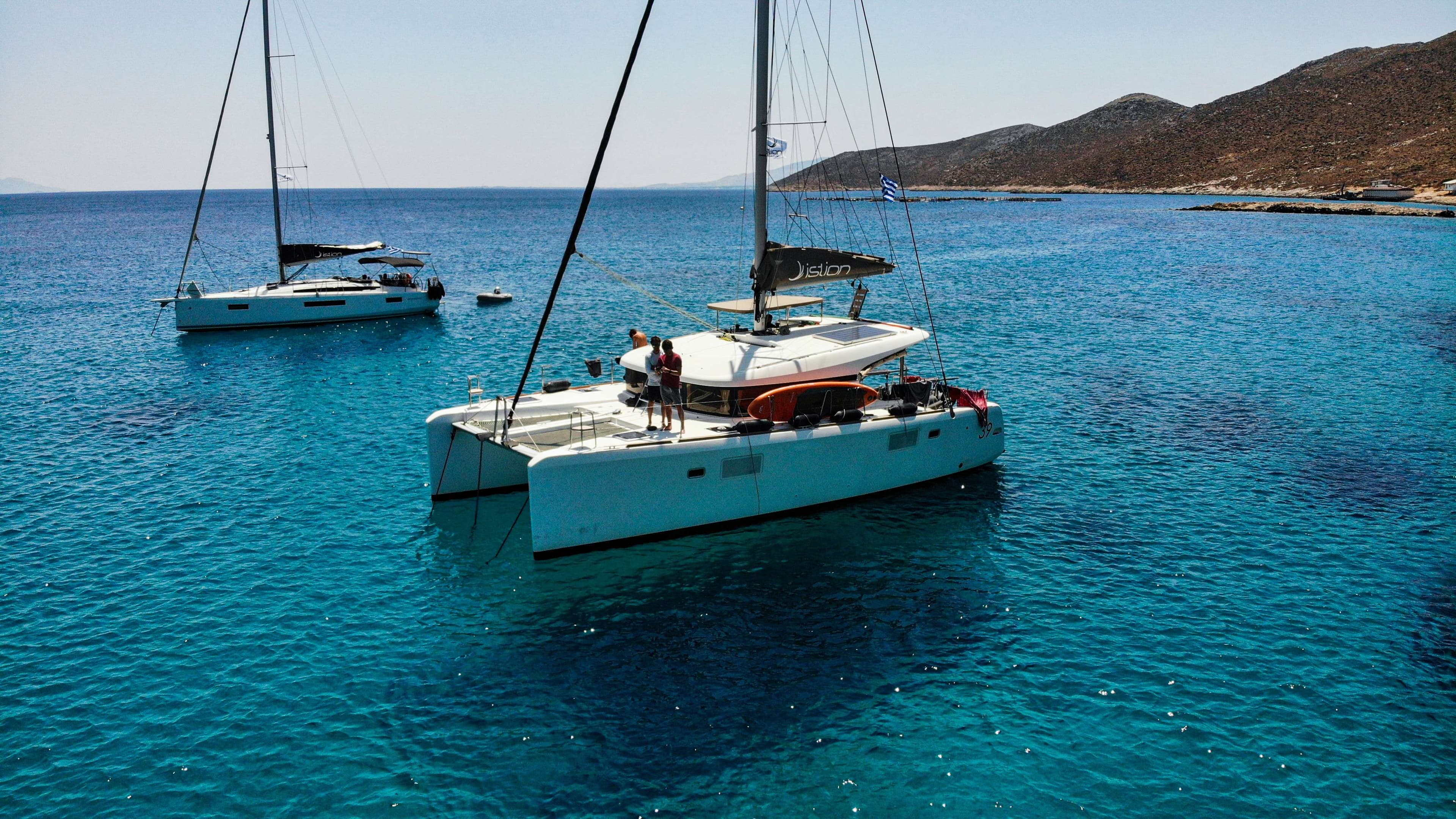 Boats in the water with people on them in the water.