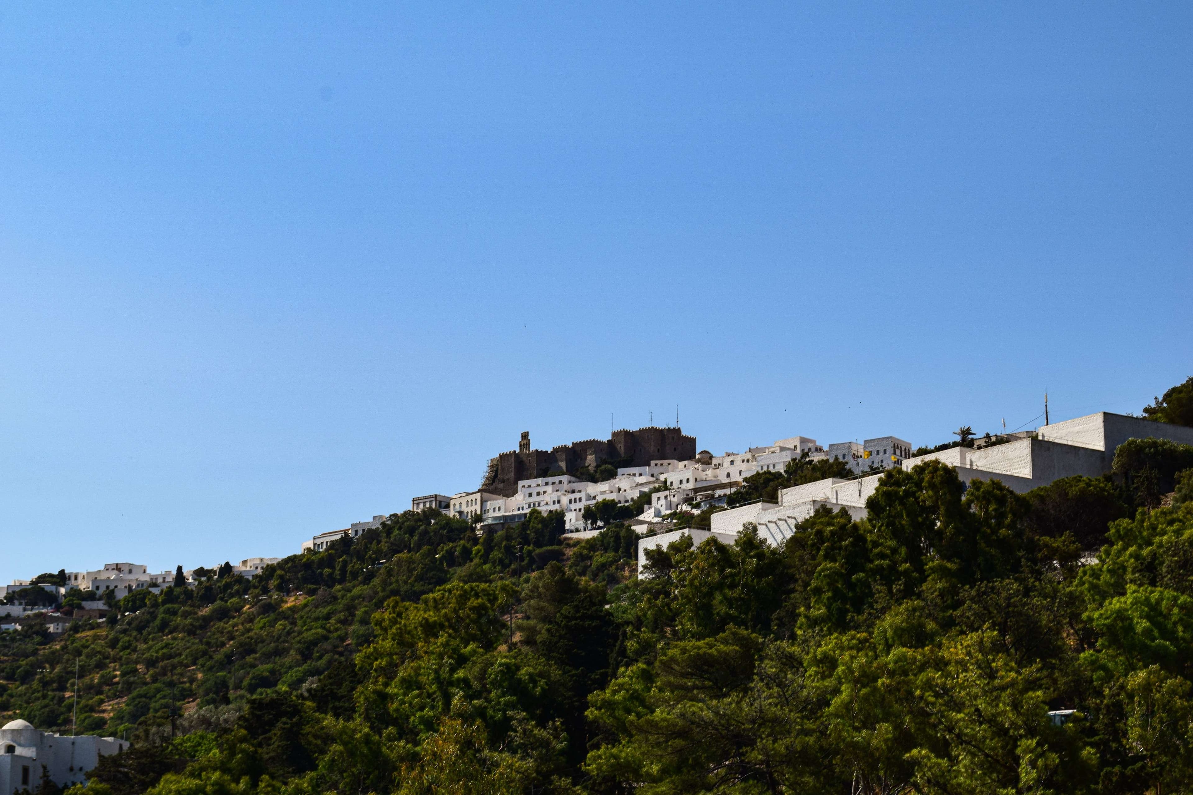 There is a large hill with a lot of trees on it.