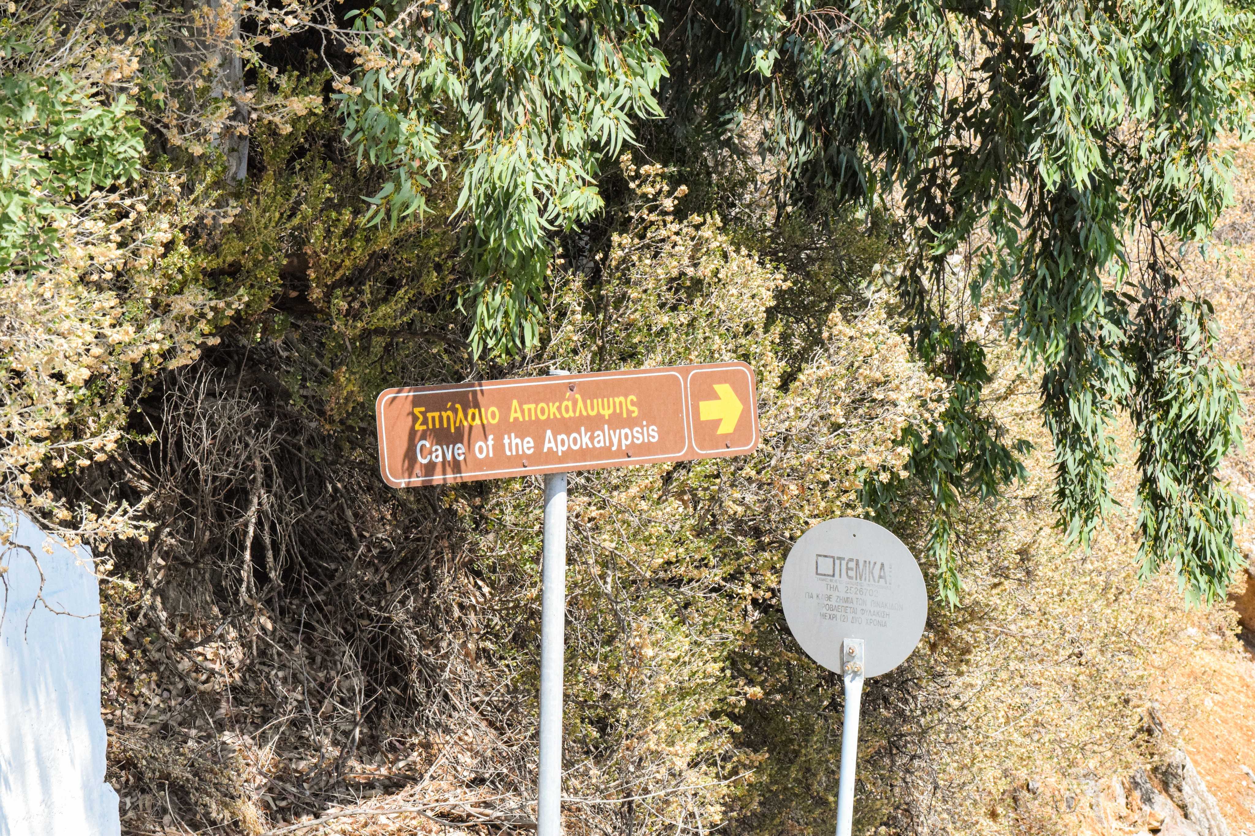 There are two signs on the side of the road that read the direction.