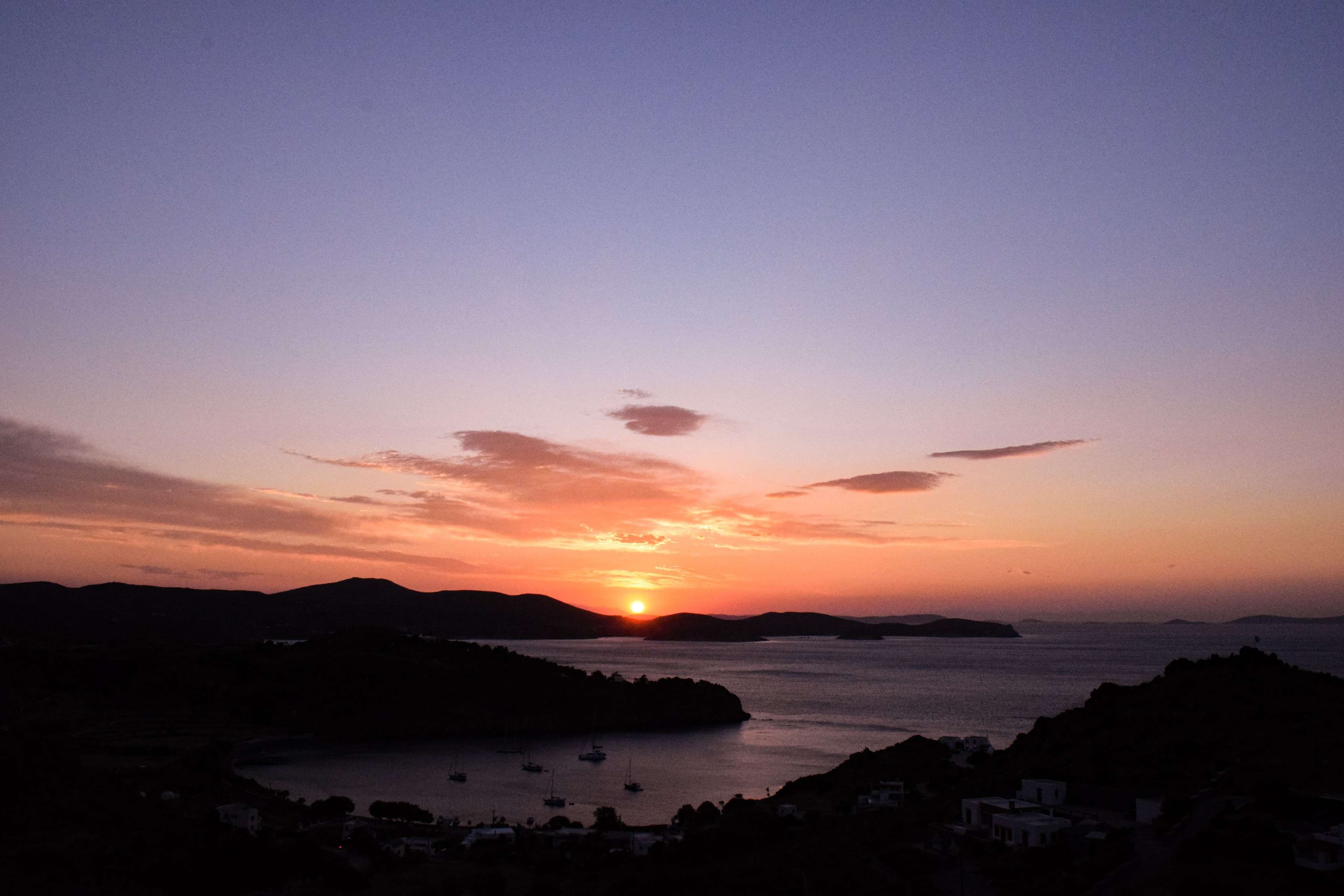 Arafed sailboat docked in a harbor with a mountain in the background.