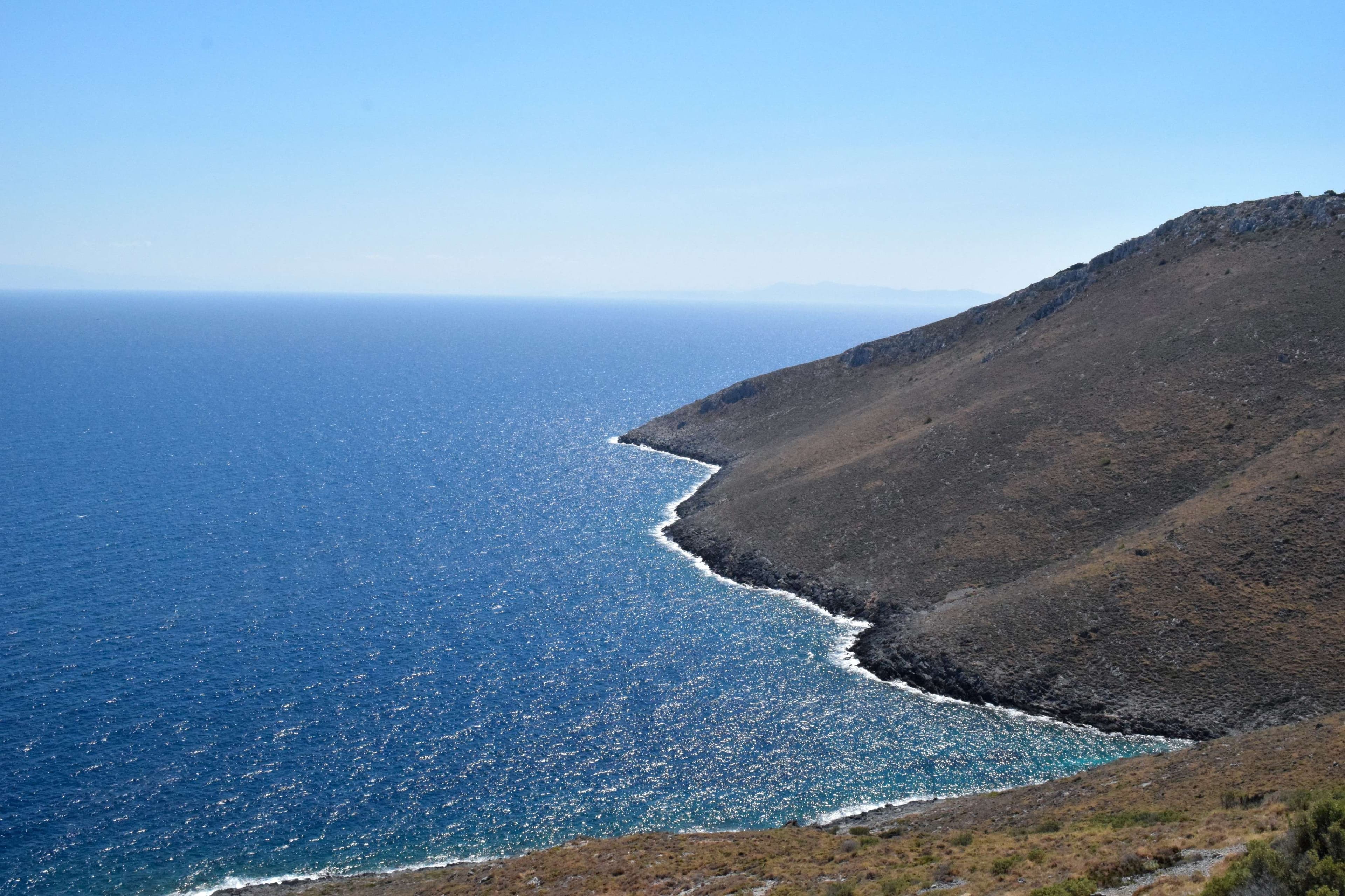 Arafed view of a bay with boats and a city in the background.