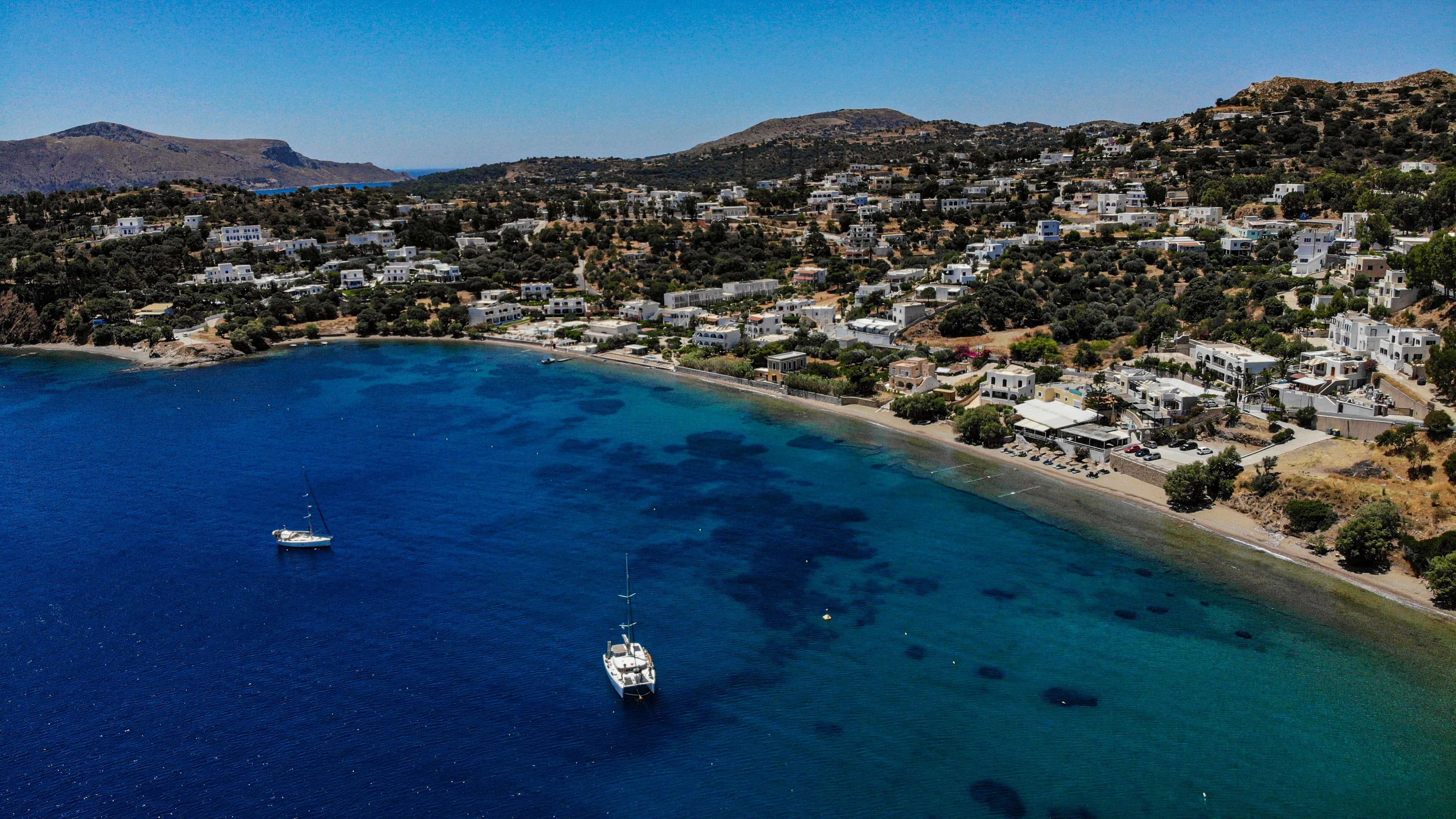 There is a small church on a mountain with a steeple.