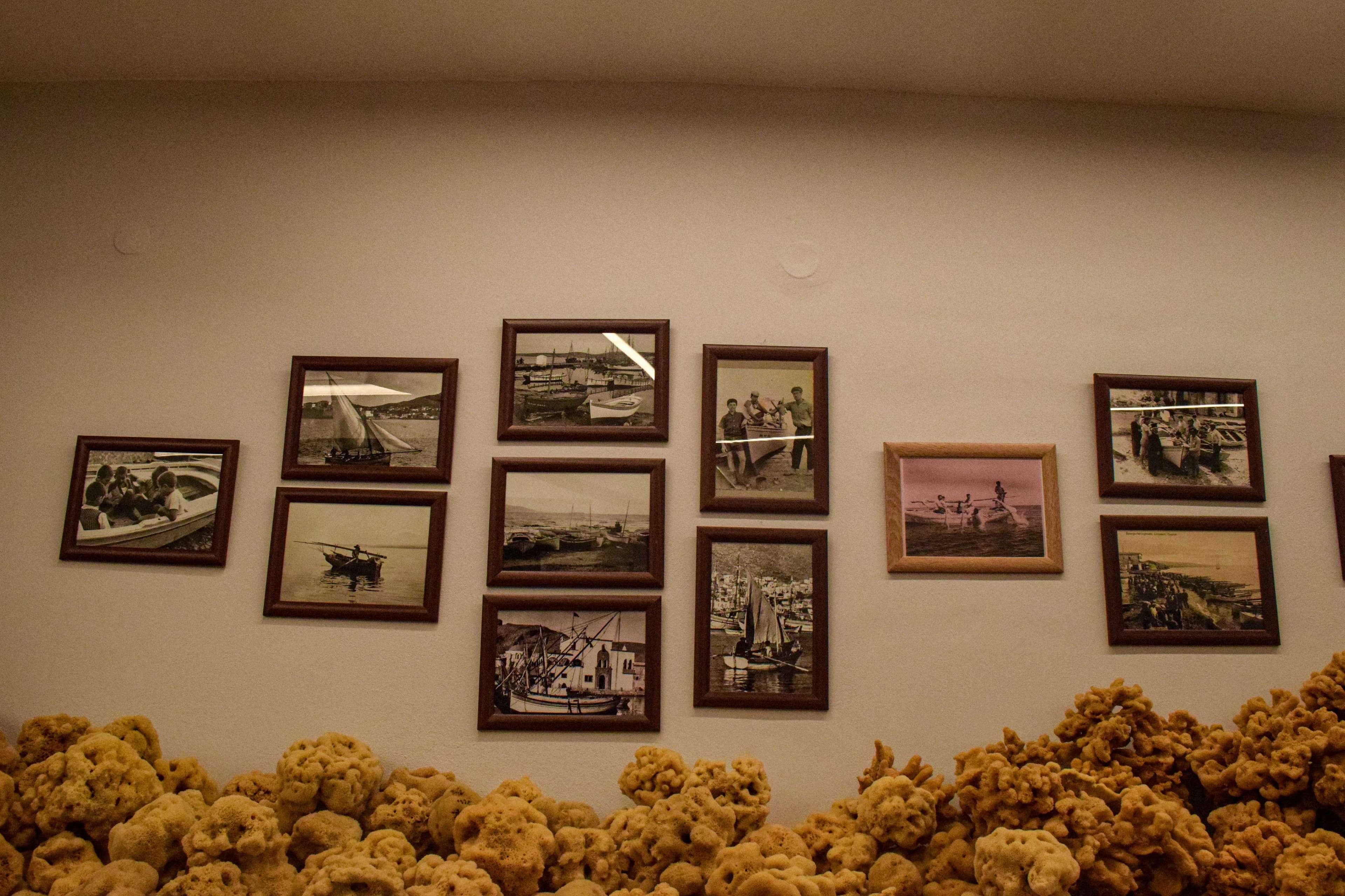 There are two men sitting on the bow of a boat.