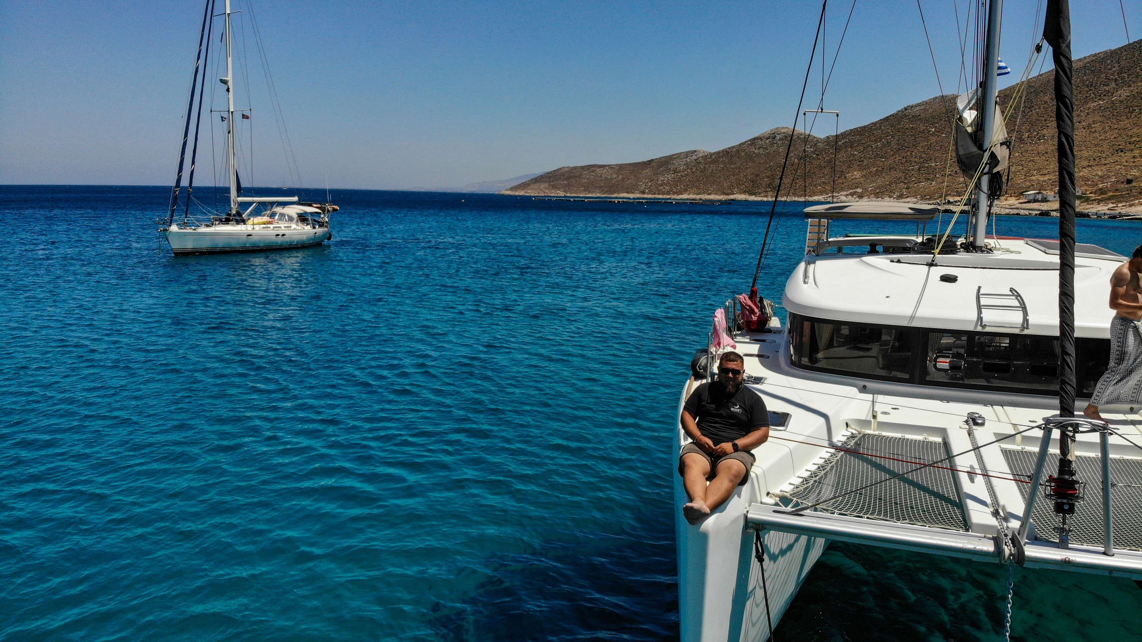 There is a man sitting on a boat in the water.