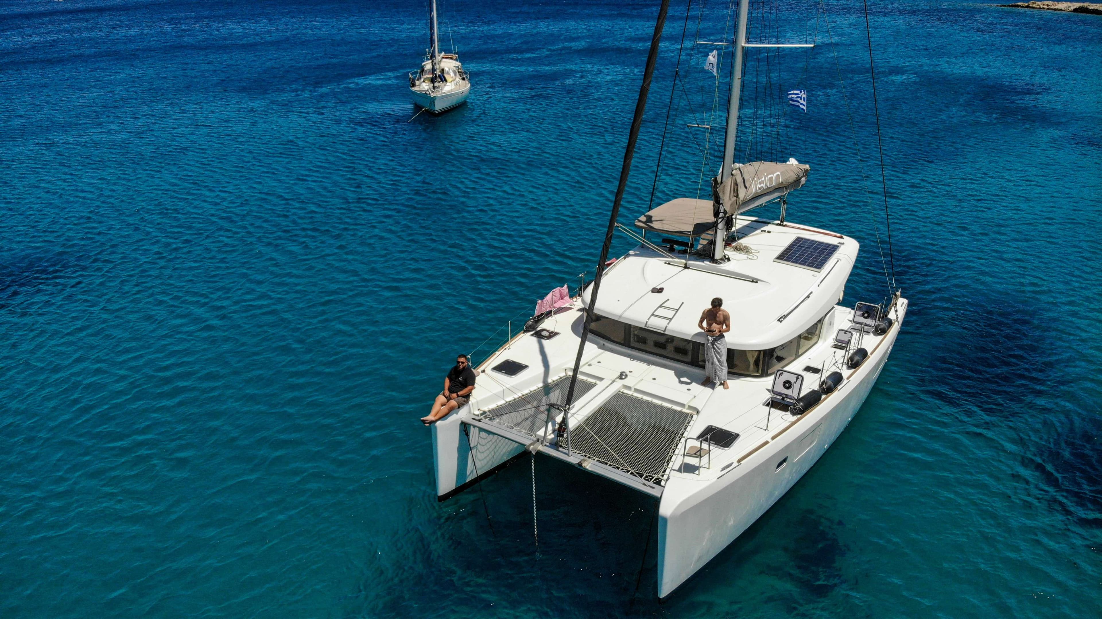 Arafed sailboat in the water with two people on deck.