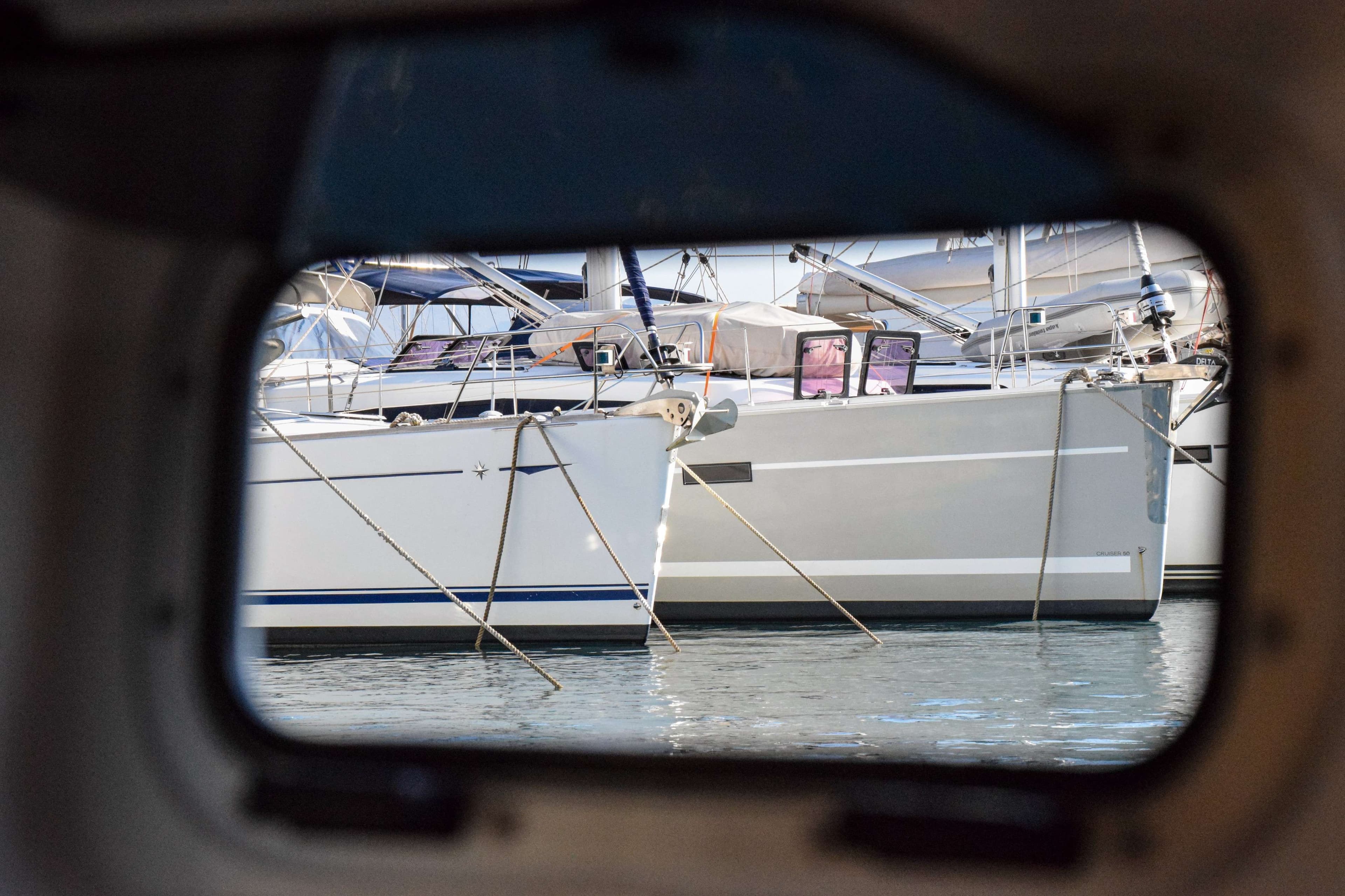There are many boats in the water and one is white.