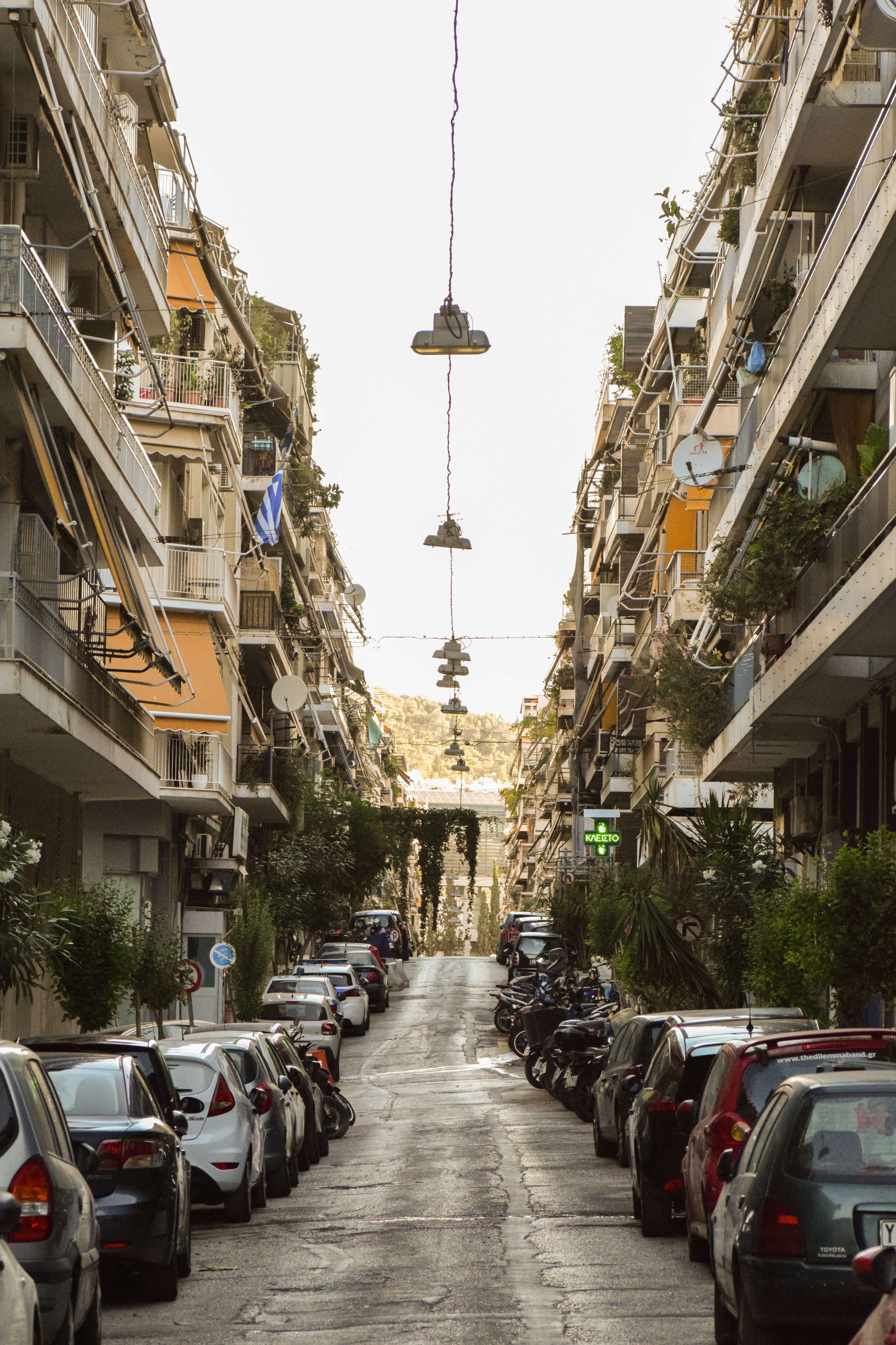 Cars parked on the side of a street in a city.